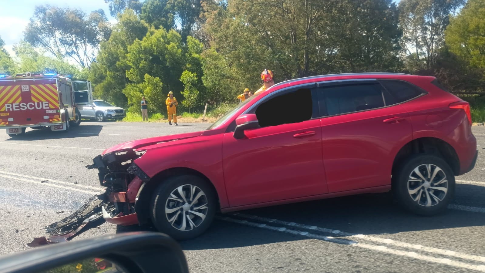 Firefighters attend to one of the drivers at the scene, whilst awaiting the arrival of paramedics. It's understood that neither driver was seriously injured. The highway remains closed whilst emergency services work to clear it.