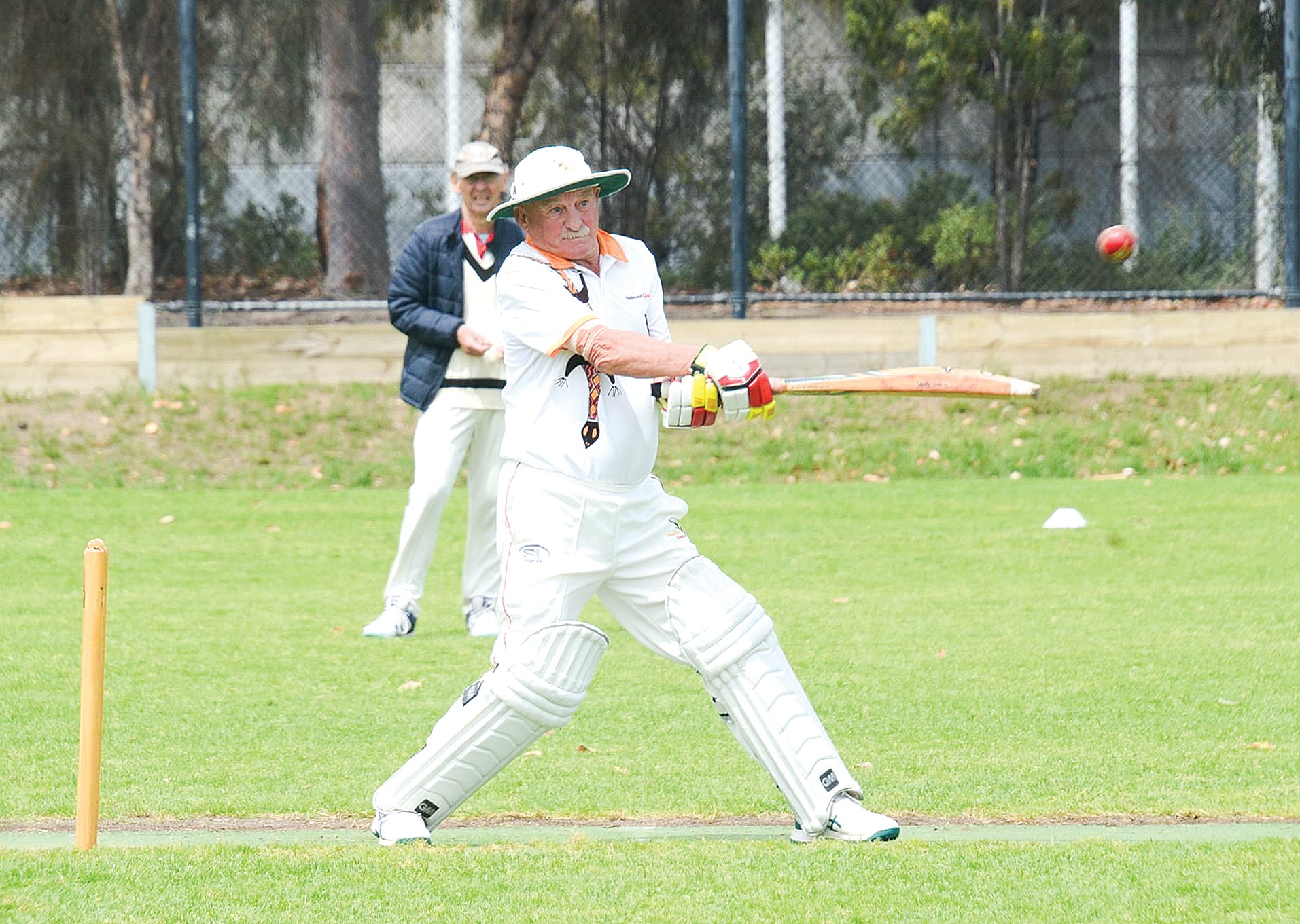 Gippsland Goannas president Neil Meredith cuts during his innings of 34 not out.&nbsp; Ian Southall is the square leg umpire.
