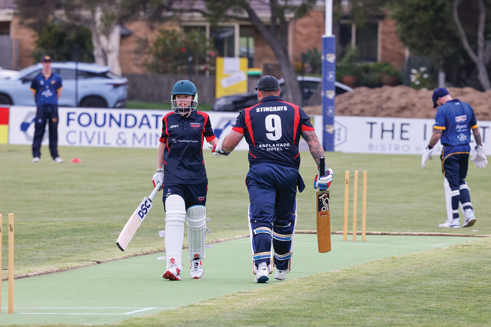 Invy’s Noah McMillan, who finis hed not out, and his captain Shaun Hayes meet in the middle of the pitch, after Hayes emphasised the importance of guiding youth at the club. W27_4125