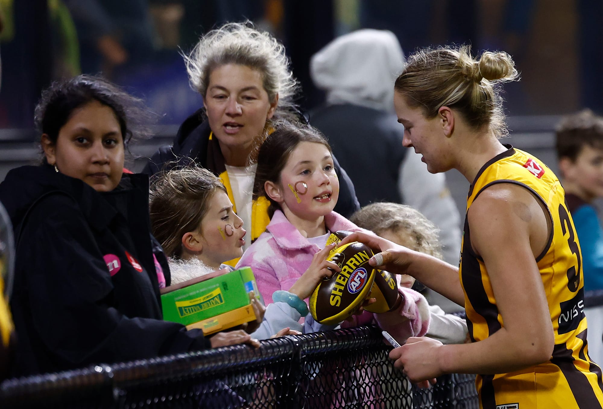 Lucy Wales signs a footy for a young fan after a Hawks AFLW match. Picture: AFL Photos.
