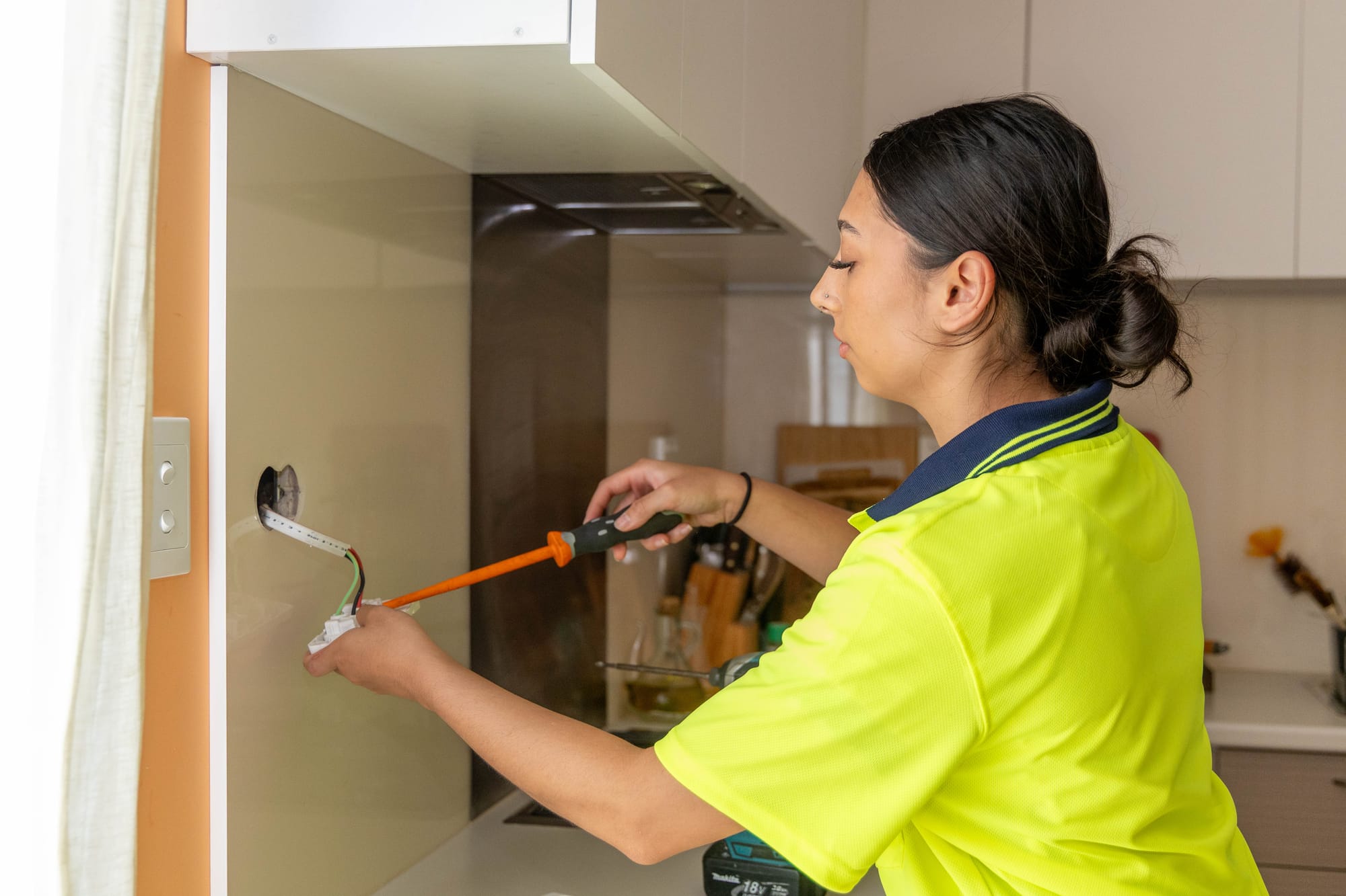 Second-year apprentice Emily Gardner carrying out some work for B.Mason Electrical.