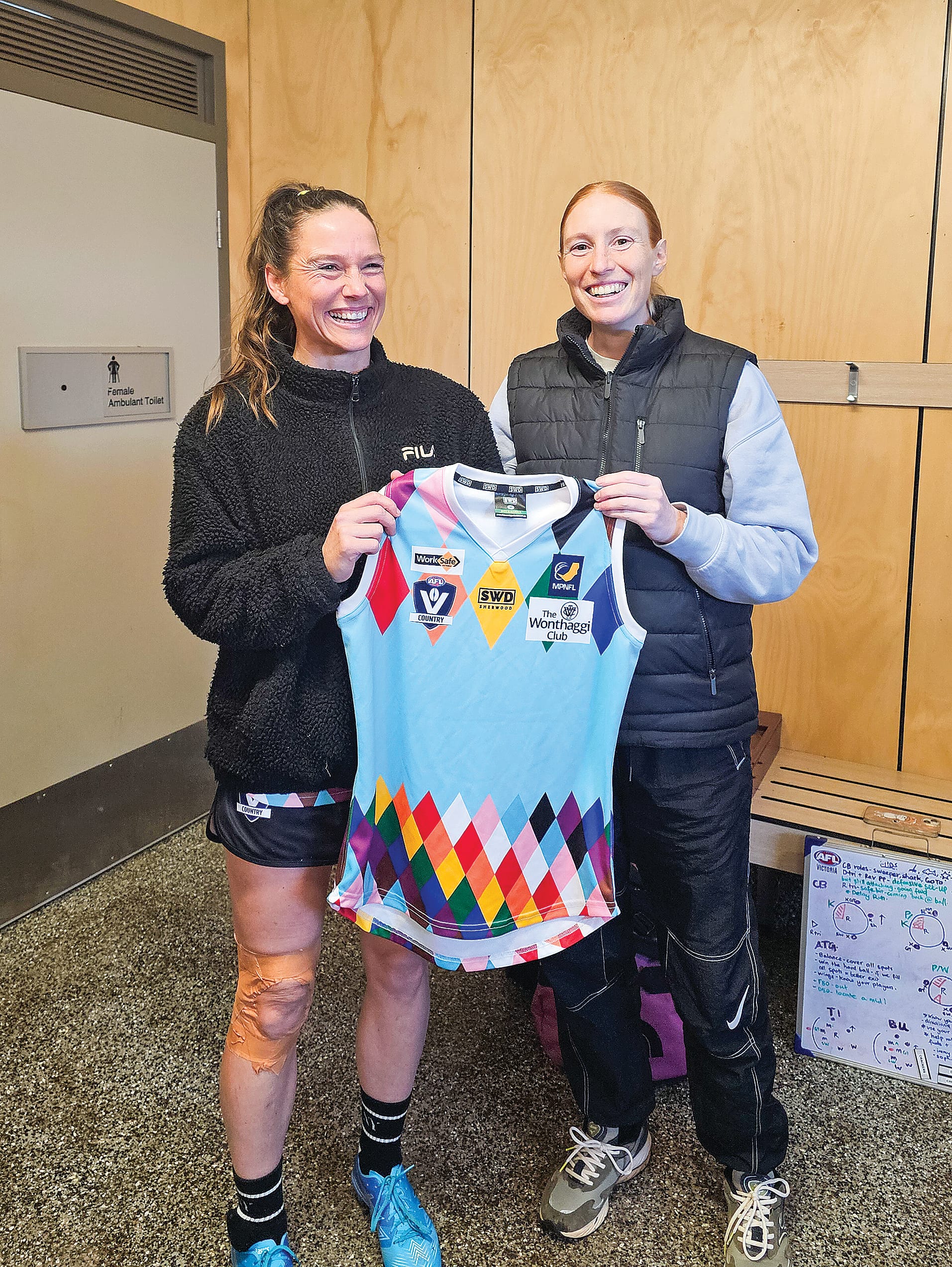 First gamer Emily Jolly receives her jumper from coach Ali Drennan.