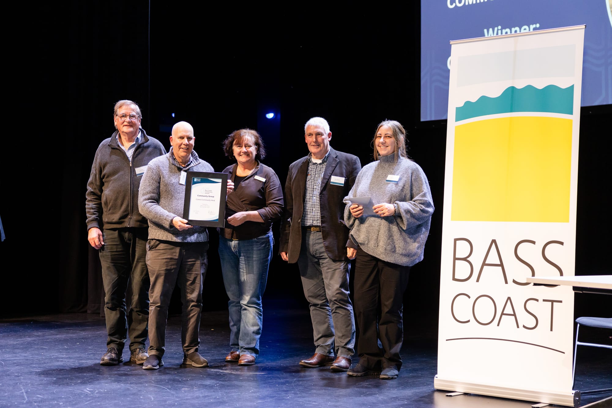 Cowes Community Meal on stage with their award