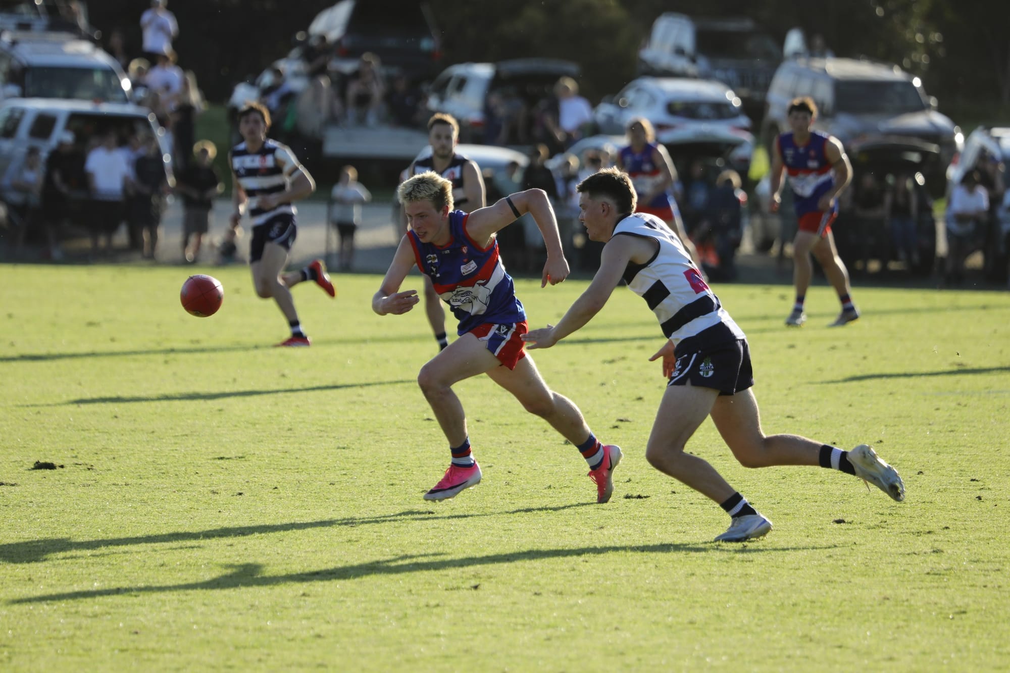 Phillip Island player chases the loose ball in the grand final