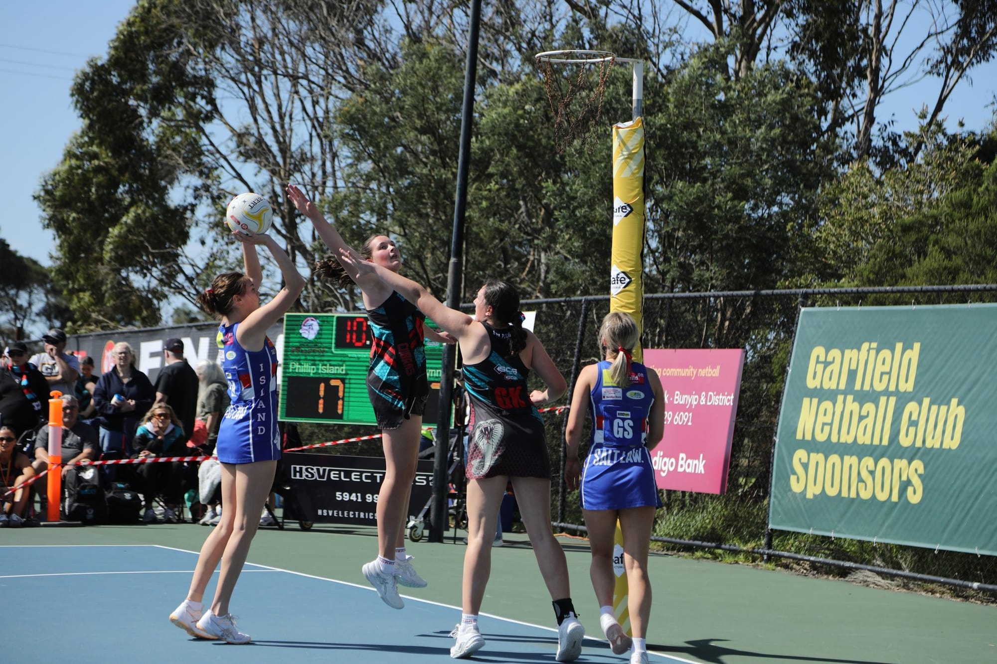 A Phillip Island netballer shoots for goal under pressure