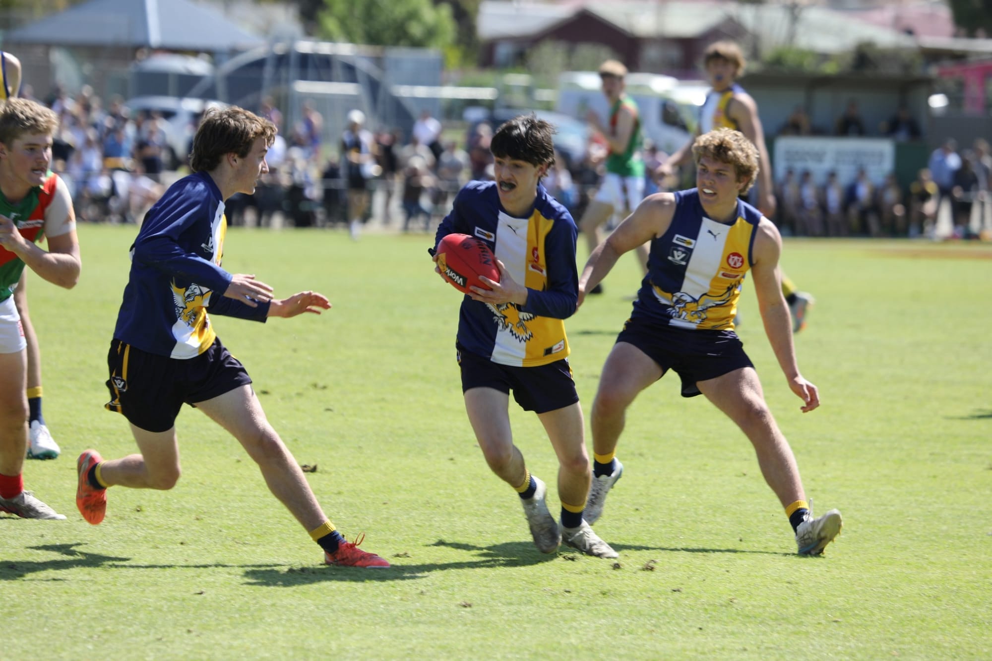 An Inverloch-Kongwak player runs with the ball in the thirds grand final
