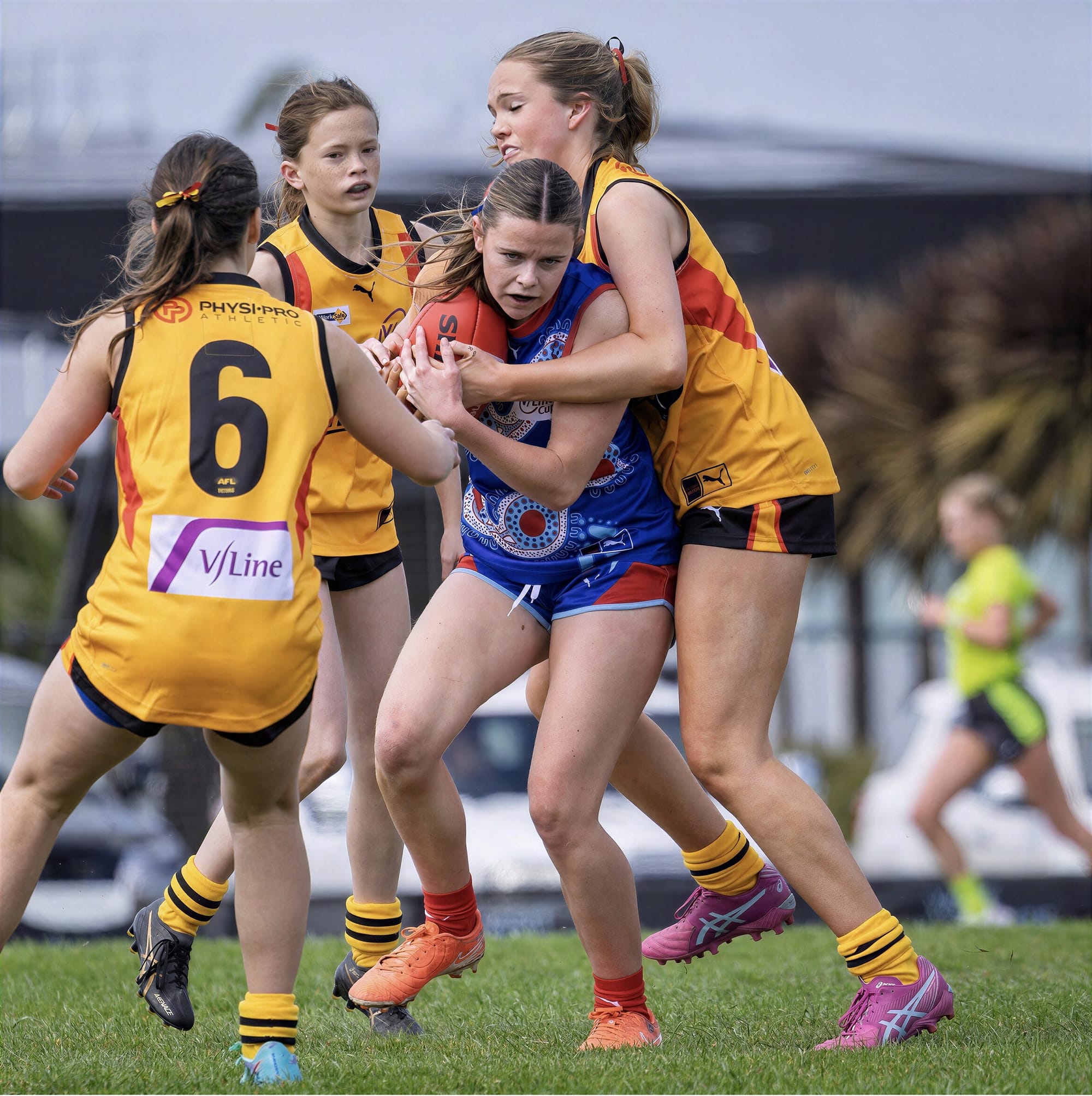 Isla Curtin holds on to the ball as three South East opponents close in.