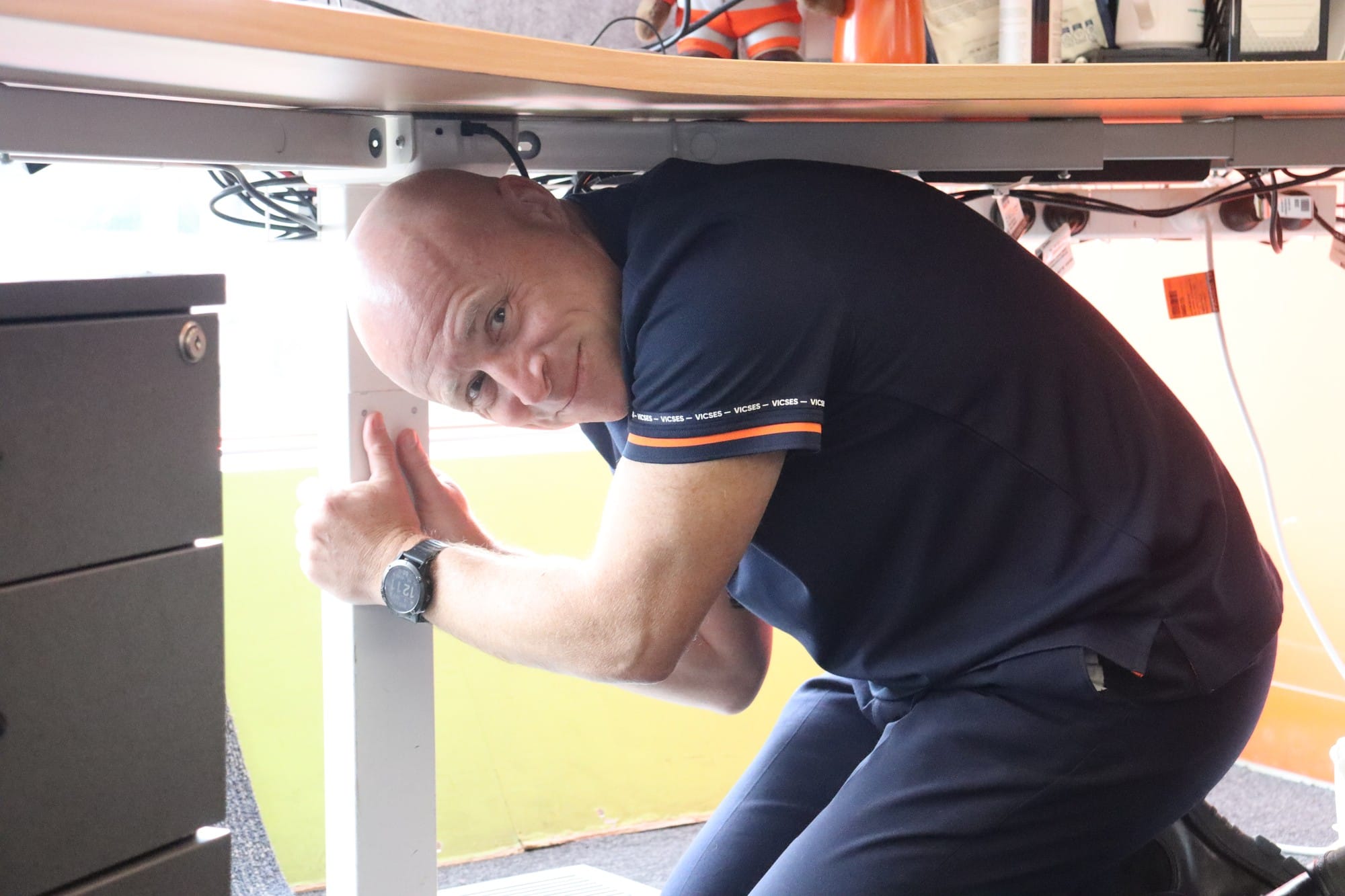 VICSES Operations Manager Gerry Sheridan sheltering under a desk