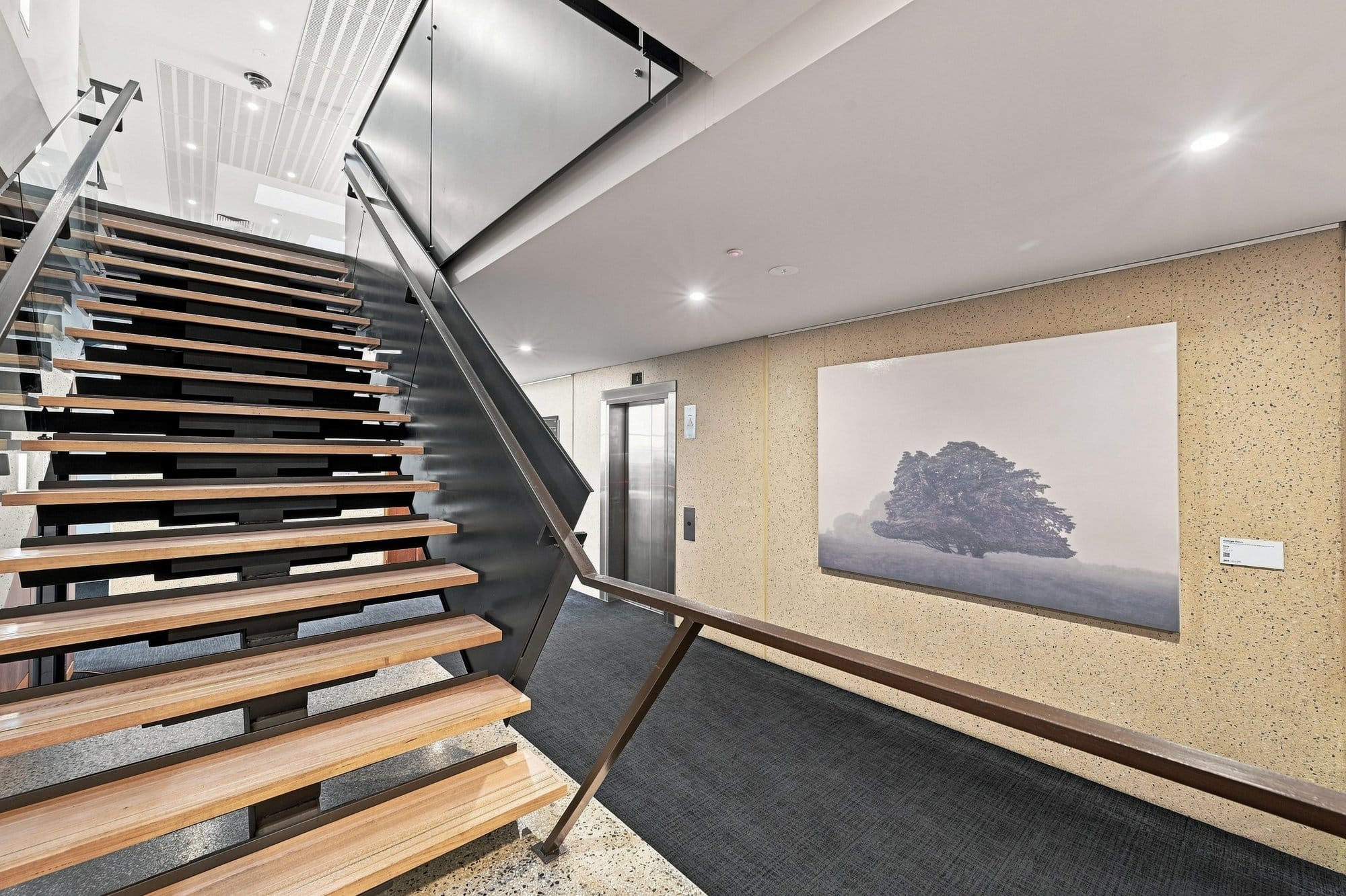 One of Kathryn Ryan’s large tree paintings hangs beside the stairs at RACV Inverloch Resort.