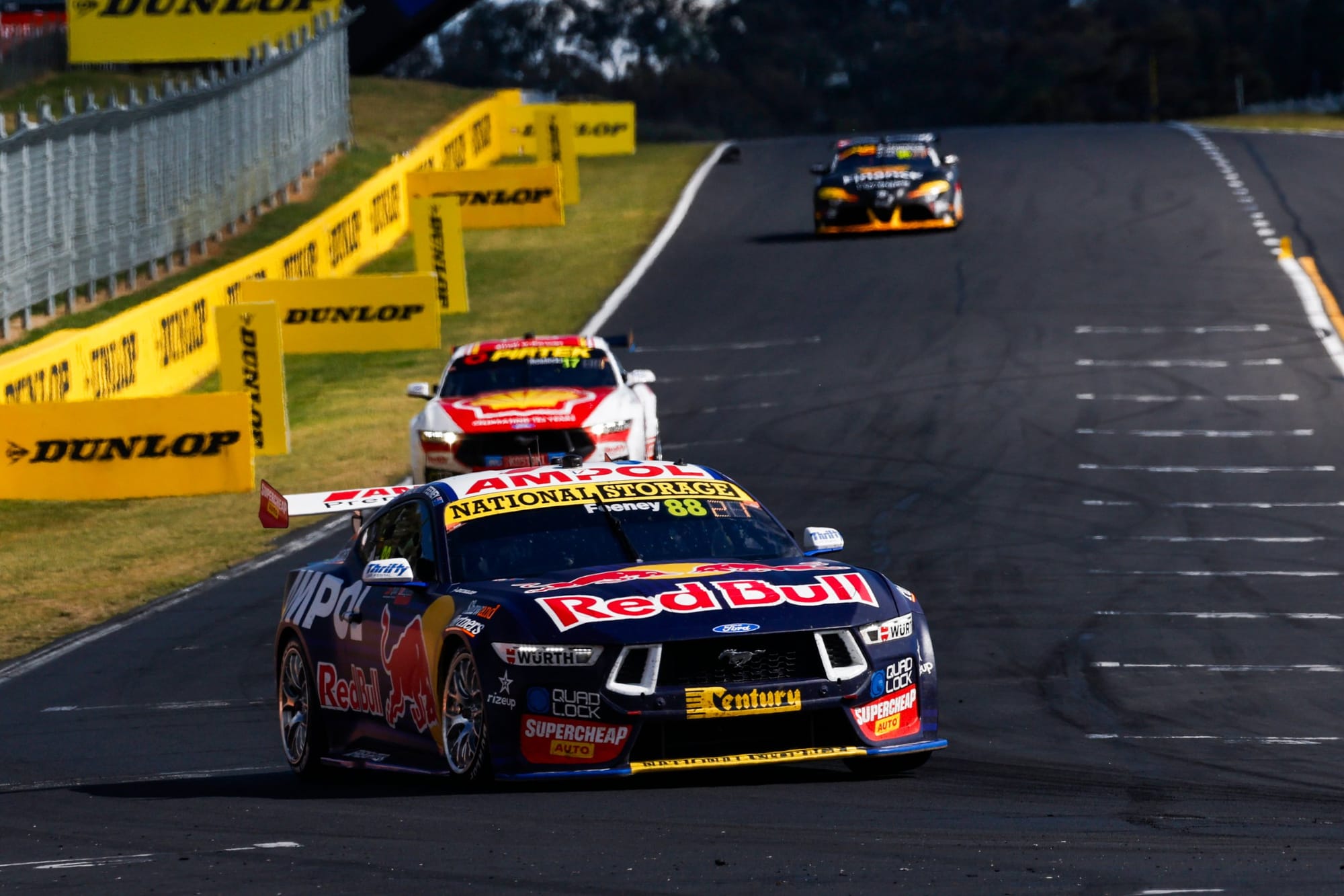 Supercars racing down a straight at Mount Panorama
