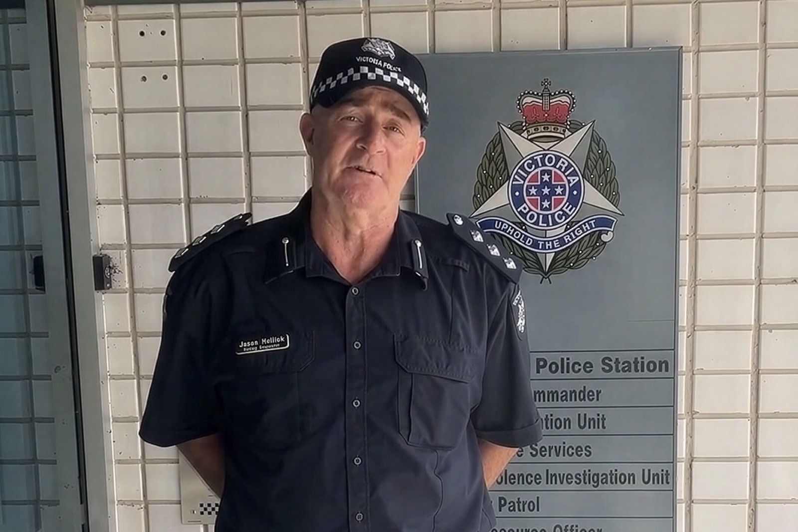 Acting Inspector Jason Hullick in uniform outside a police station