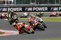 Casey Stoner leads the pack on his Repsol Honda
