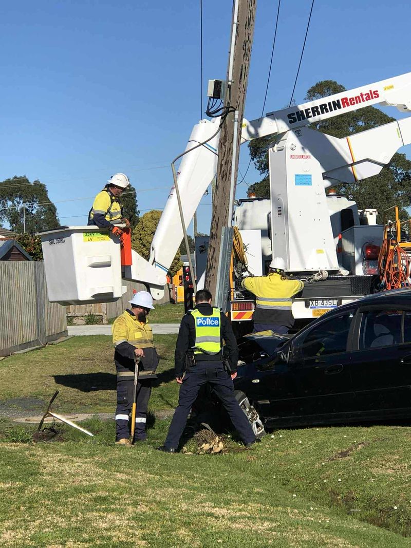 Car snaps power pole in collision post image