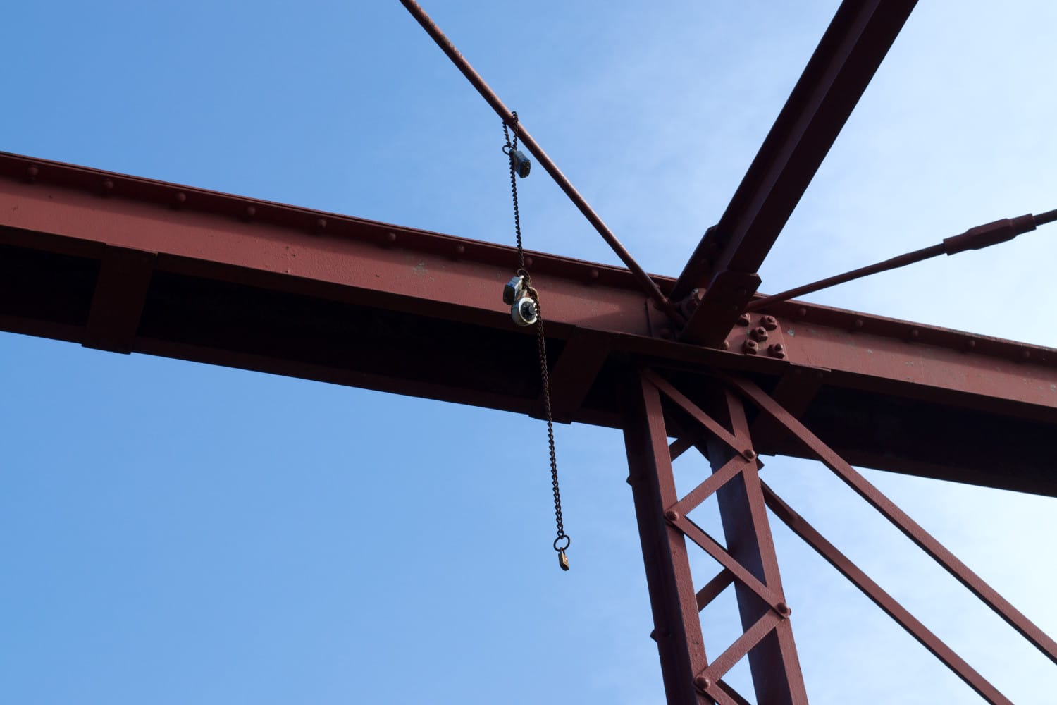 Padlocks hanging from up high at Goatman's Bridge in Denton, Texas