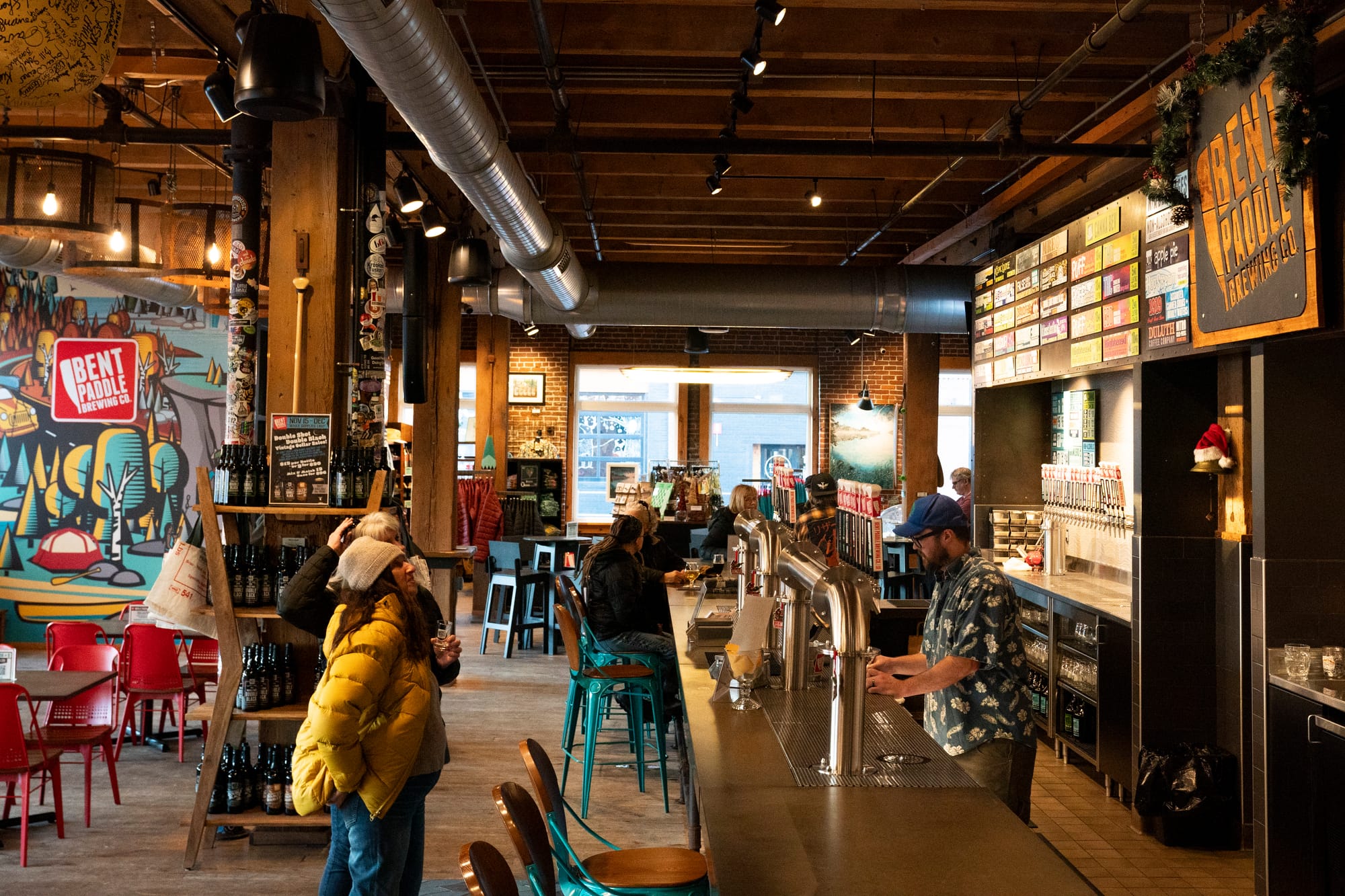 People stand at a bar to order a drink.