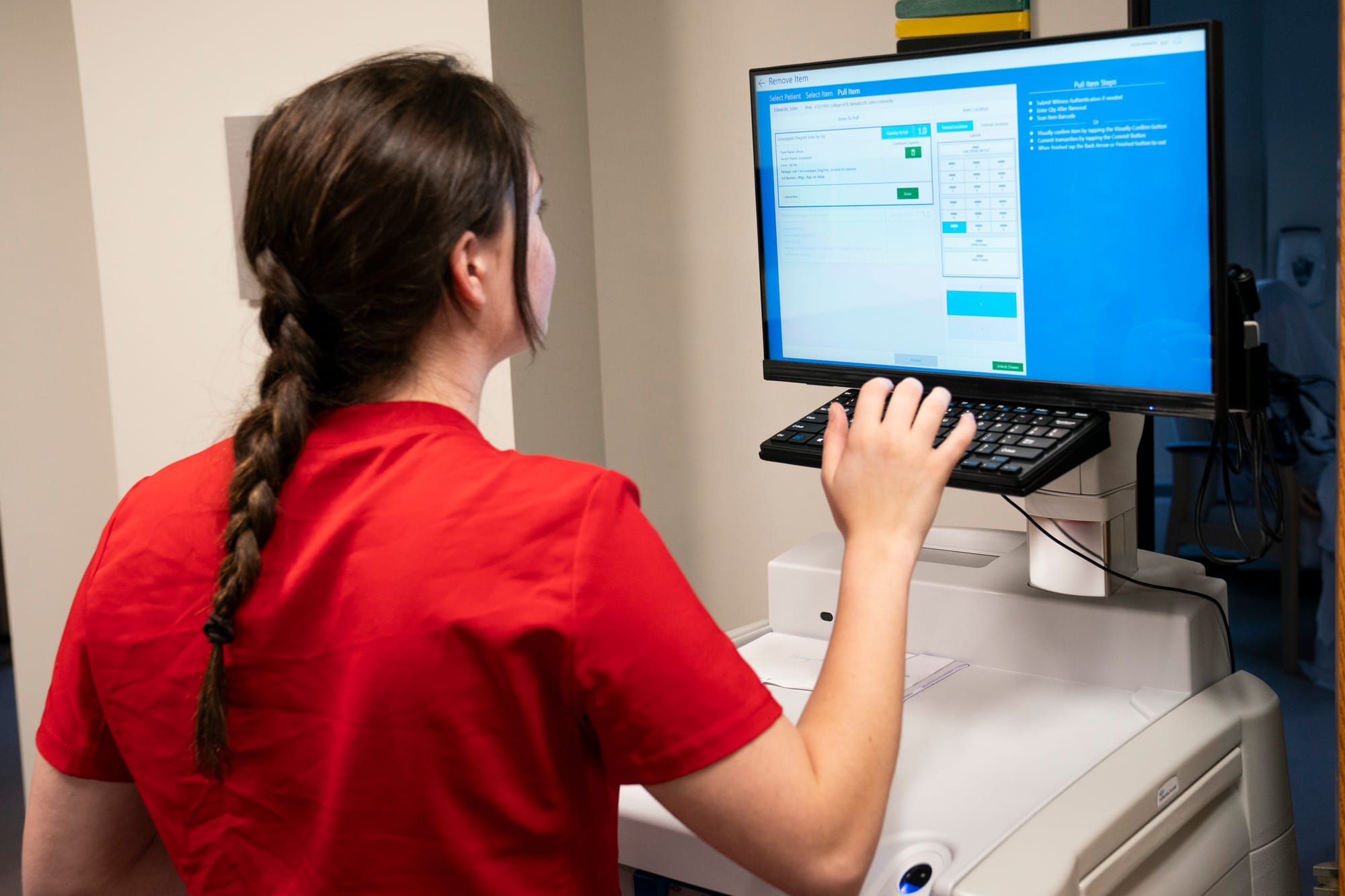 A nursing student is seen working on a computer. 