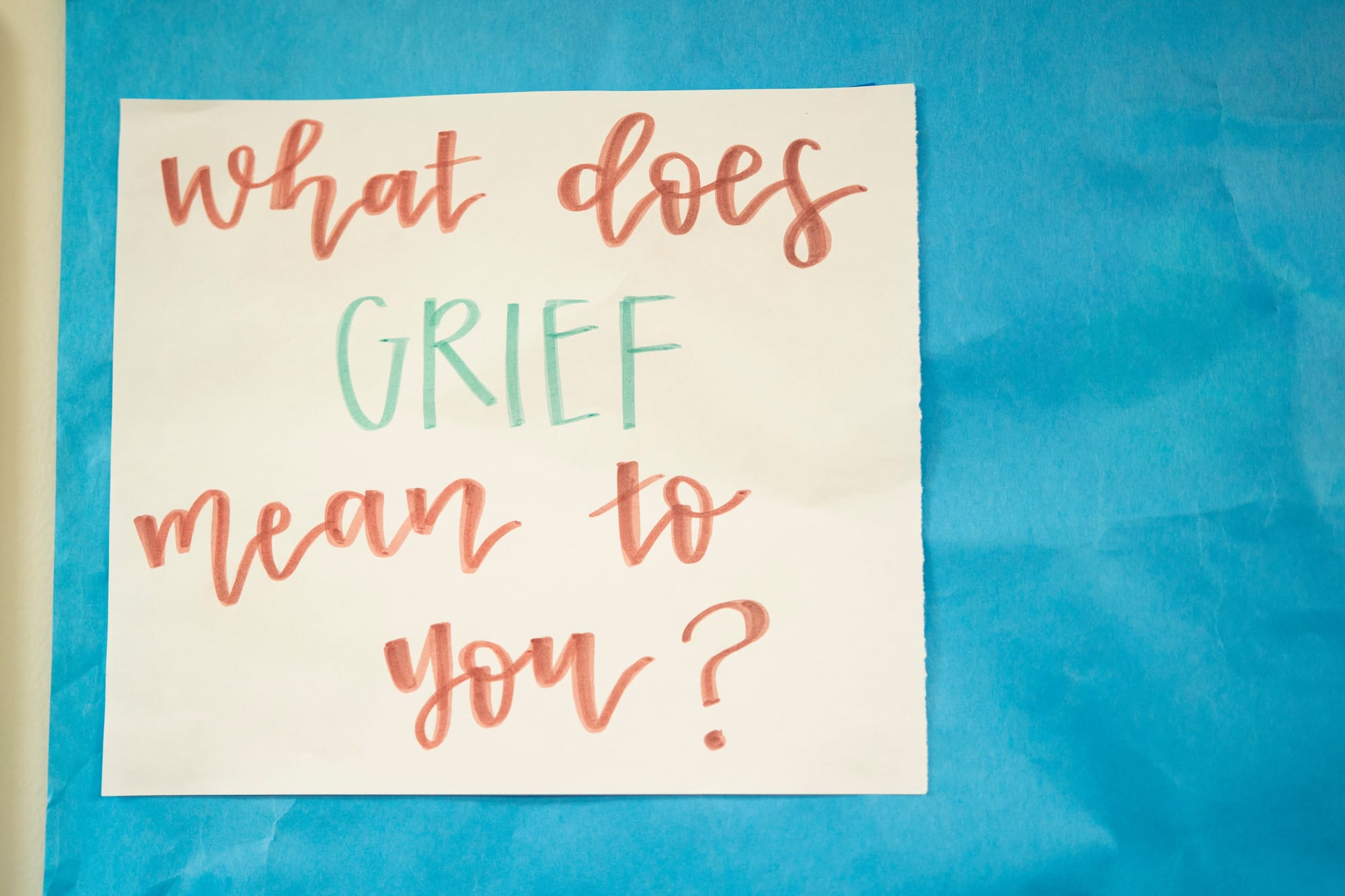 A sign in a hallway says "What does grief mean to you?" during a training exercise for nursing students. 