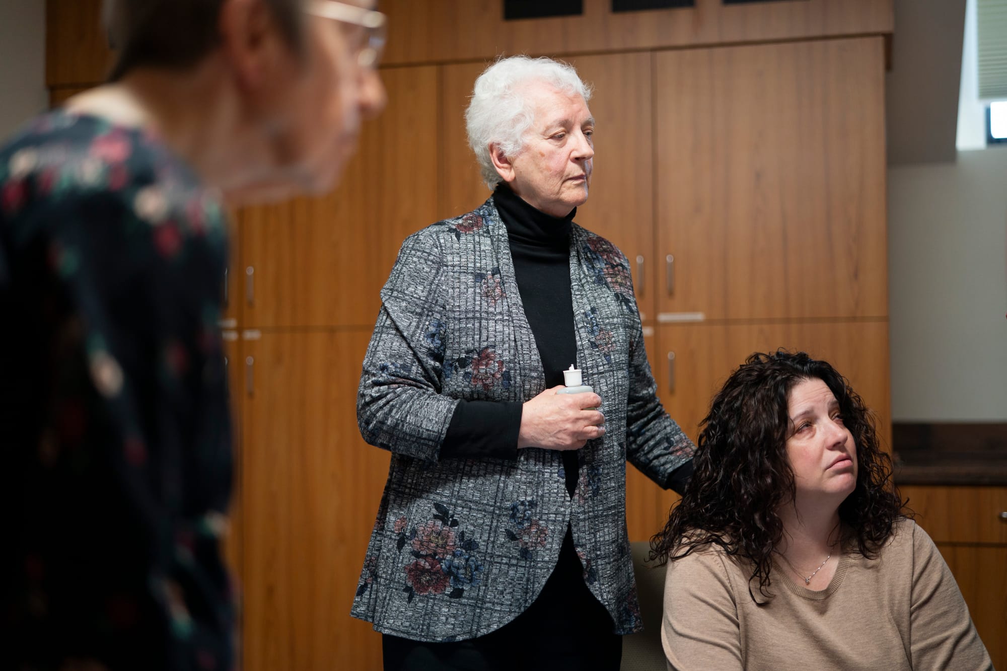 Two women are seen acting during an end-of-life training exercise for nursing students. The women are pretending to be loved ones of a patient who is dying. 