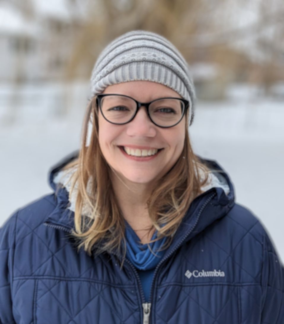 Photo of Janelle Bradley wearing a winter hat and coat and glasses