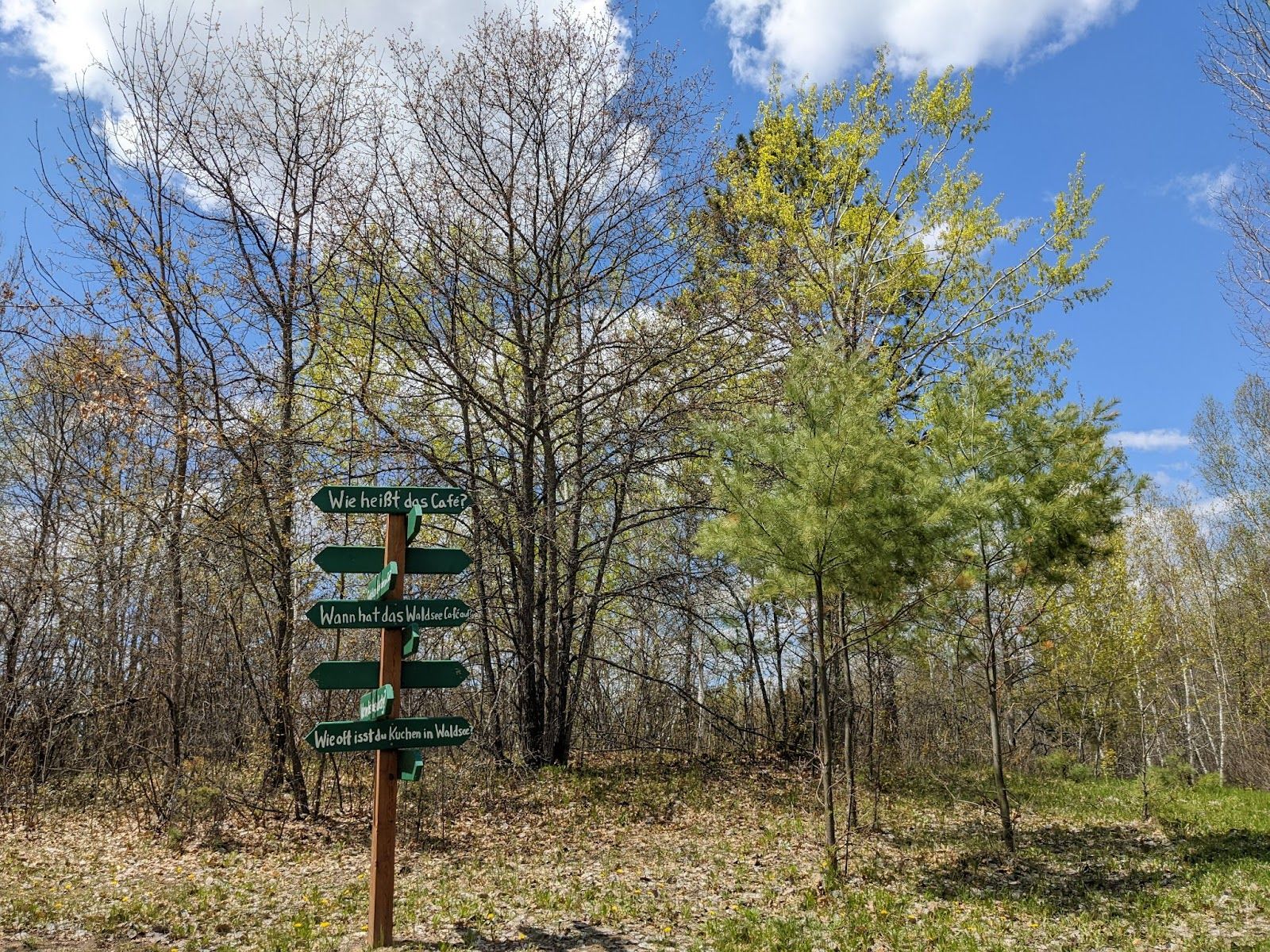 Signs in German direct campers around the Concordia Language Villages on May 23, 2022, near Bemidji, Minn. (Nora Hertel for Project Optimist)
