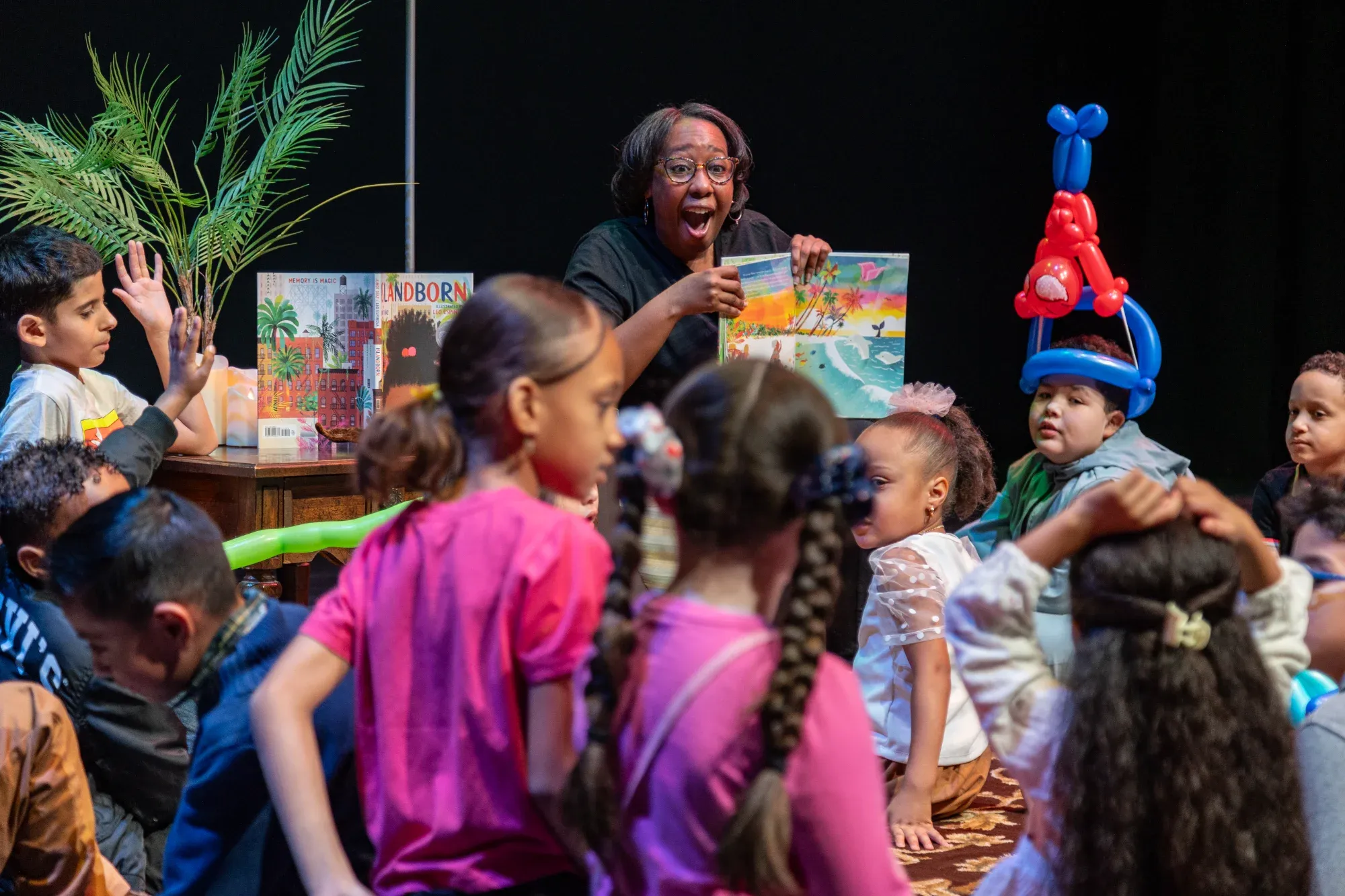 Dr. Stephanie Brown reads to children during AfroLatine Storytime