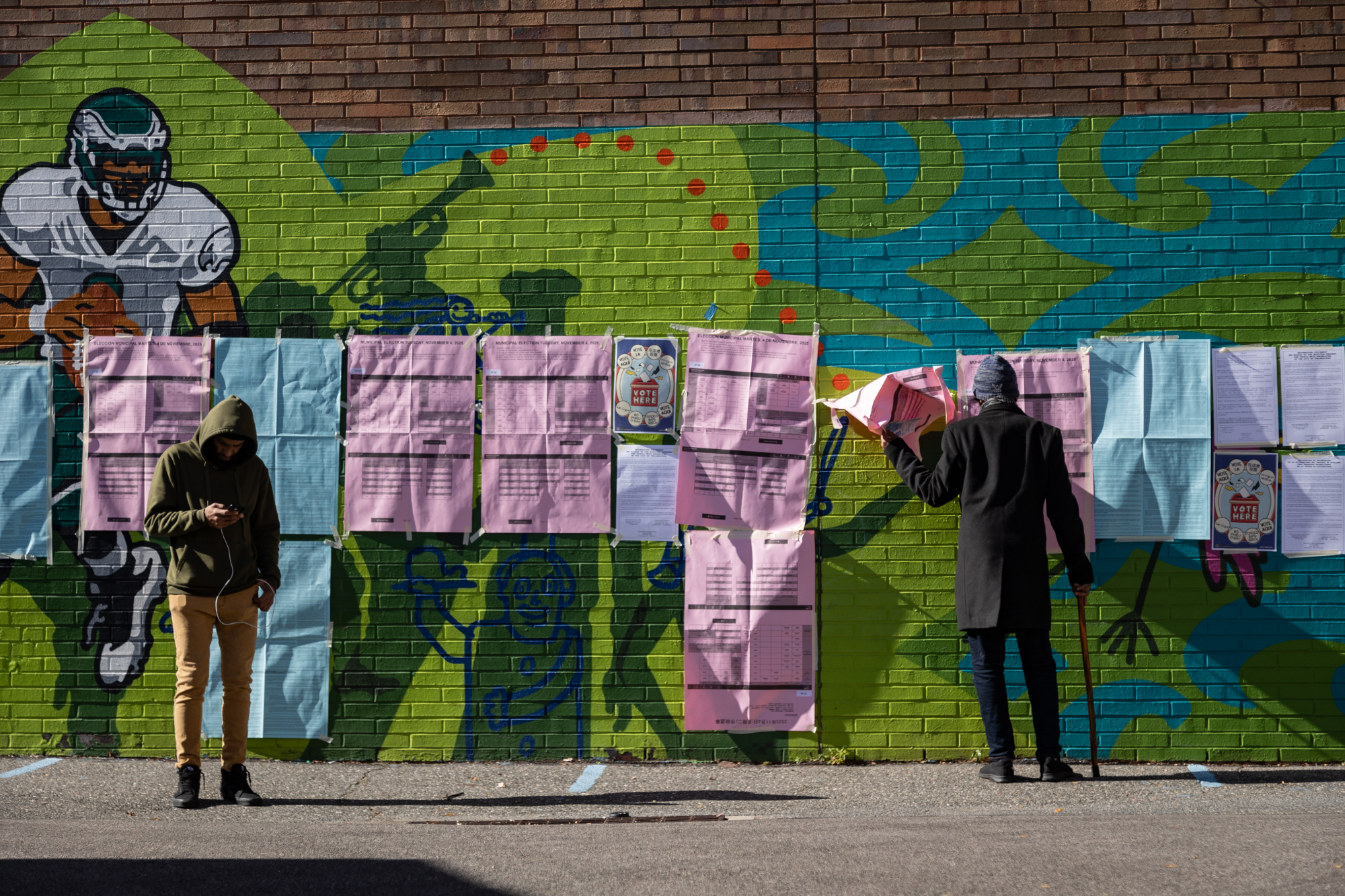Community member reads voting instructions outside Lewis Elkin Elementary School