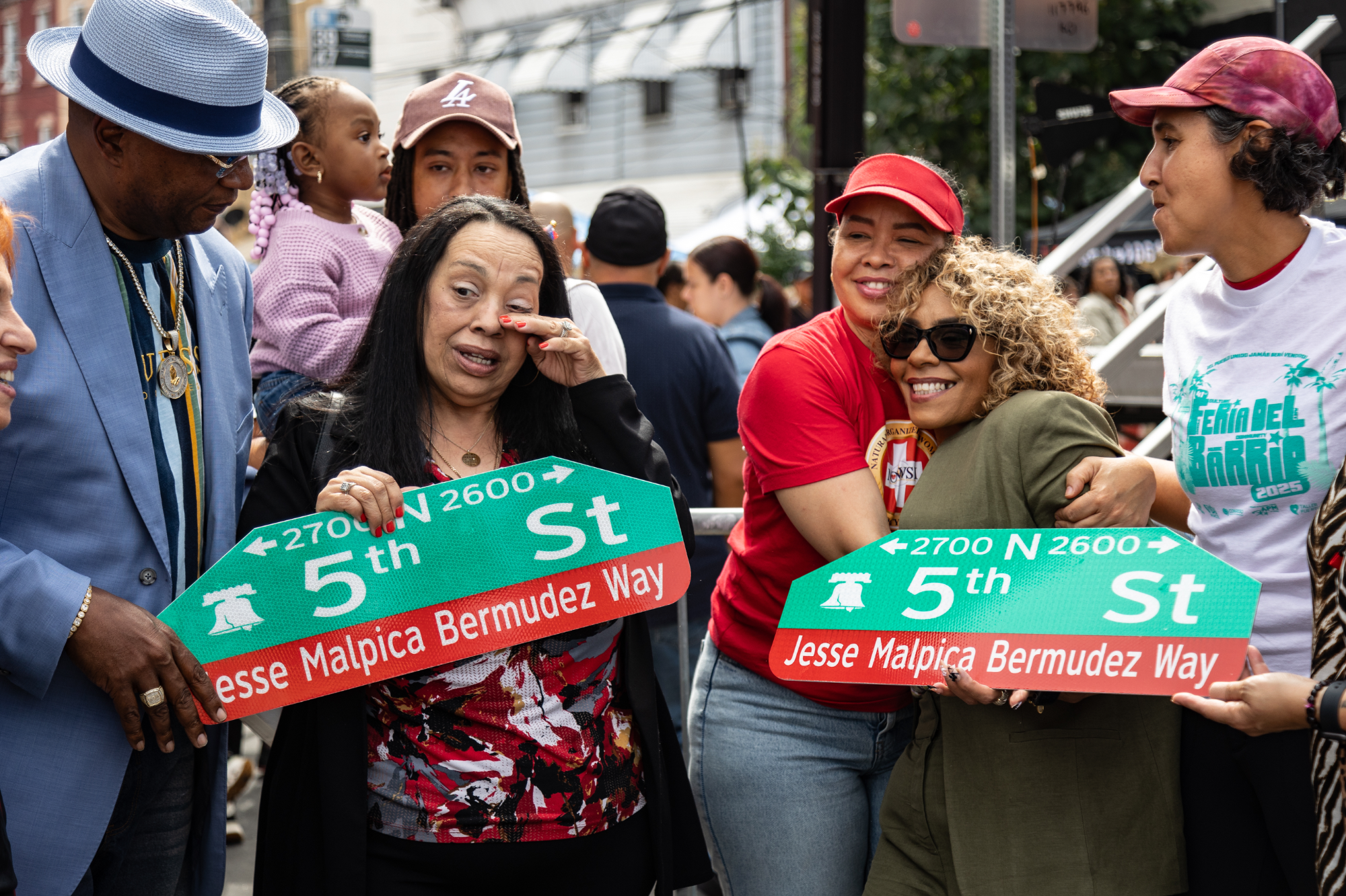 Sara Bermudez holds street sign honoring her father Jesse Malpica-Bermudez