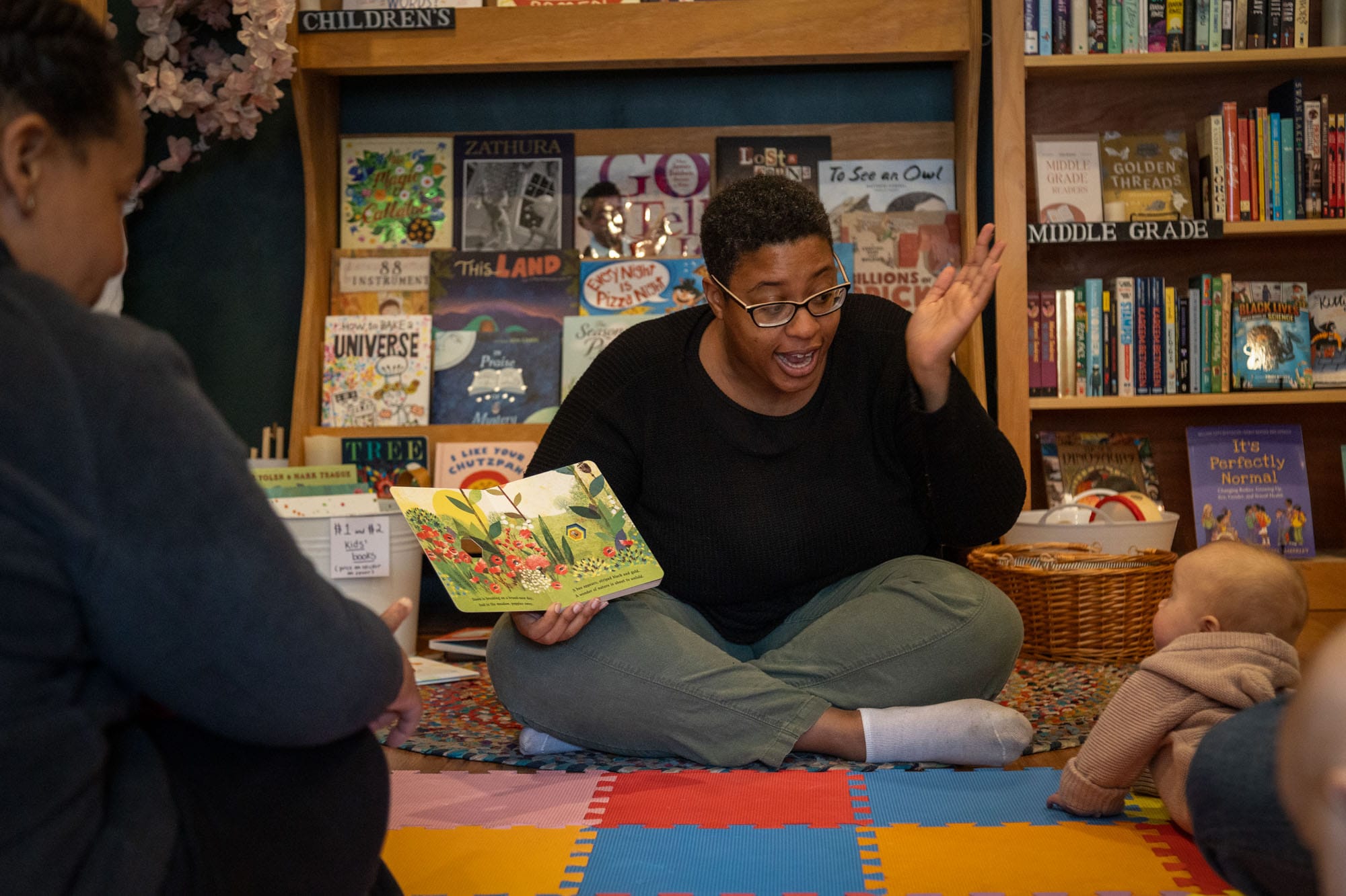 Ms. AJ reads to kids during story time at H&H Books