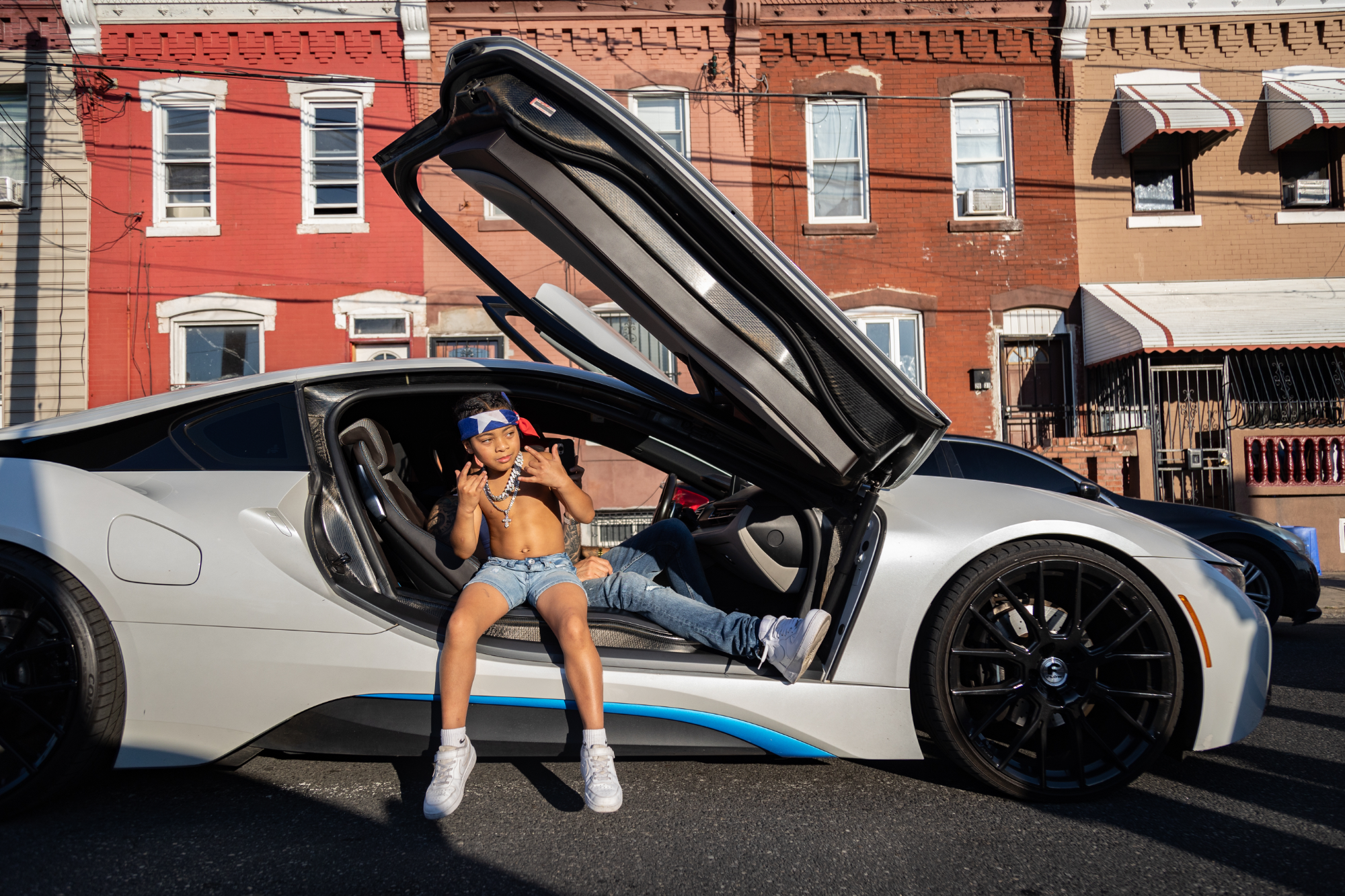 Rapper Lil GX sits in car with suicide doors open