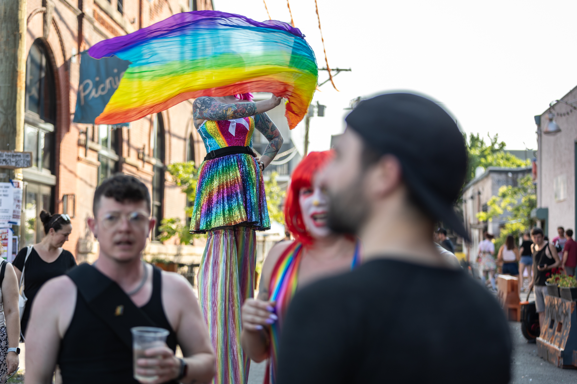 Stilt walker in rainbow dress at Kensington's first Queer Circus