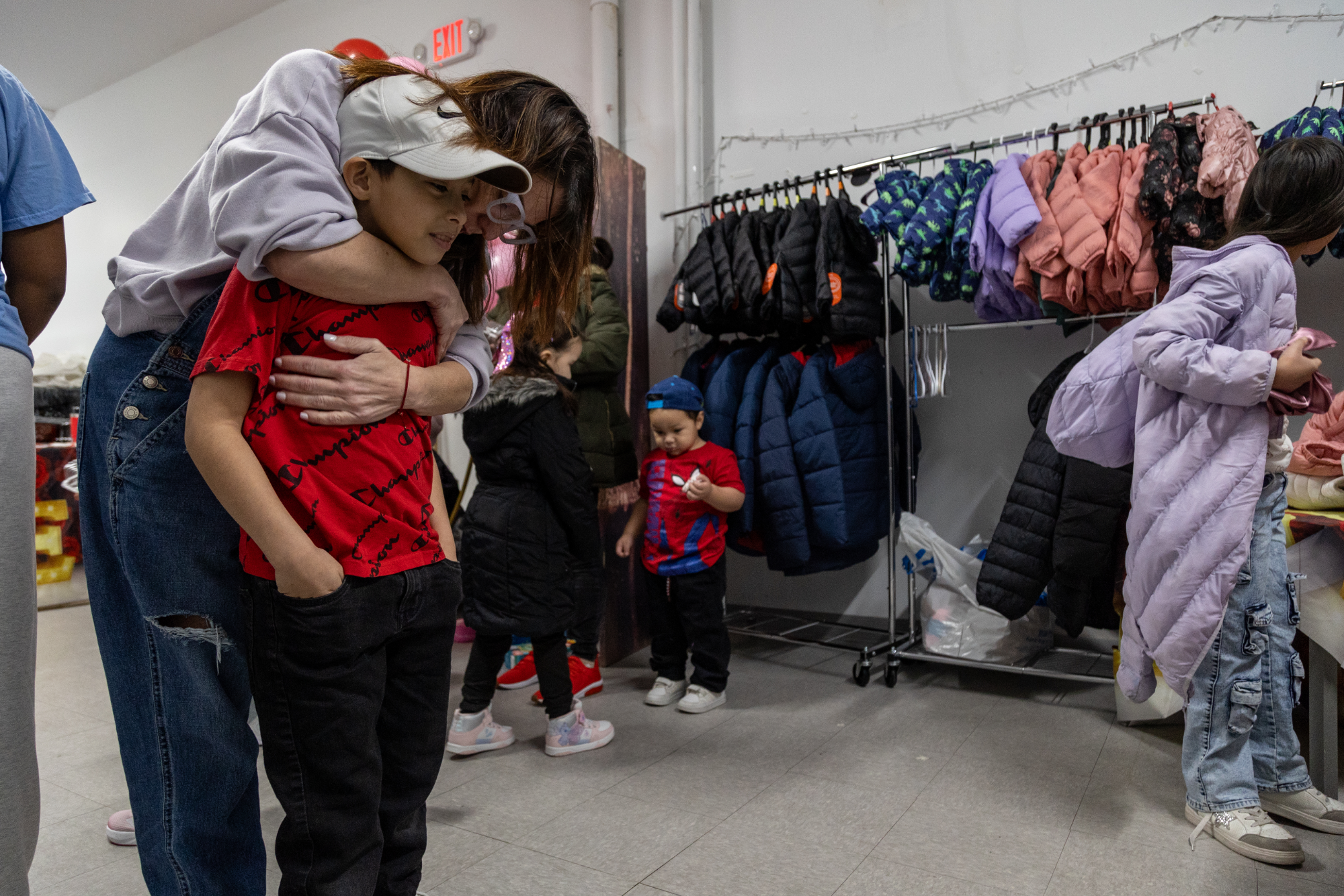 Rosa Canal hugs kids at Sunday Love Project Valentine's Day party