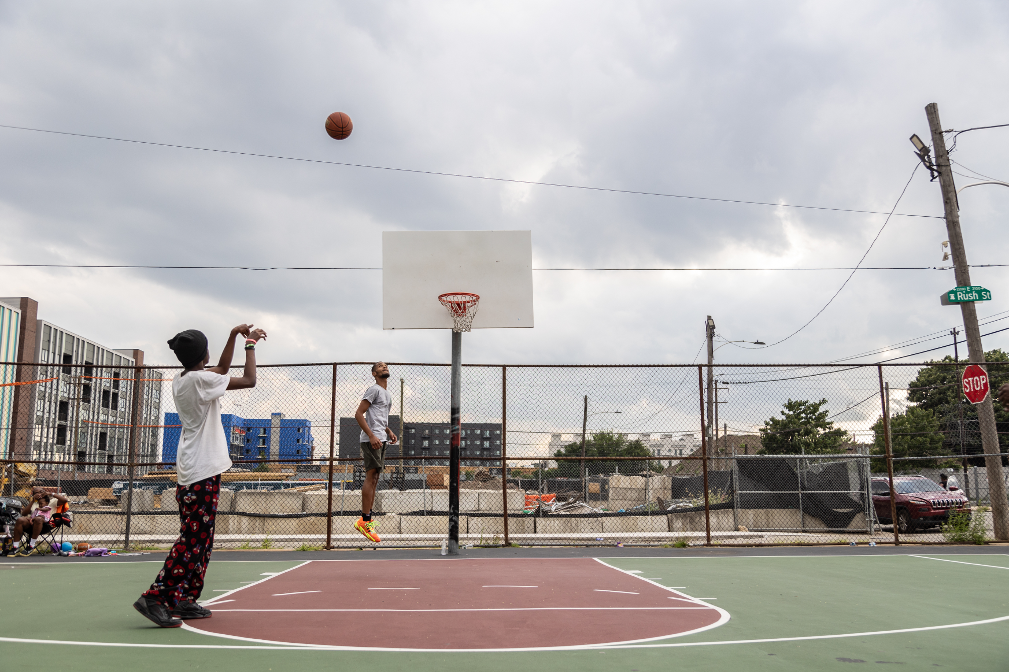 Basketball at Trenton and Auburn Playground with new housing construction in background