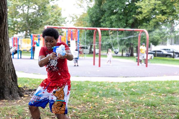 Photos of Kensington: Community members participate in the second annual "Community Water Gun Fight" in Harrowgate Park.