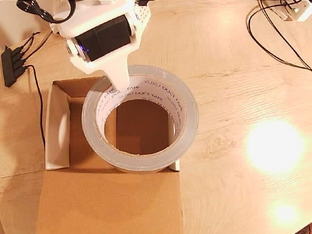 The tape overhanging the box before the first correction