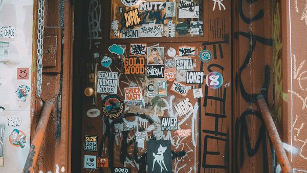 A picture of an industrial door with stickers on it