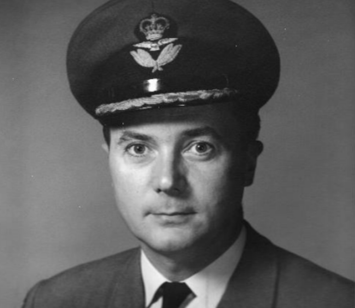 black and white photo of a stoic man in an air force uniform