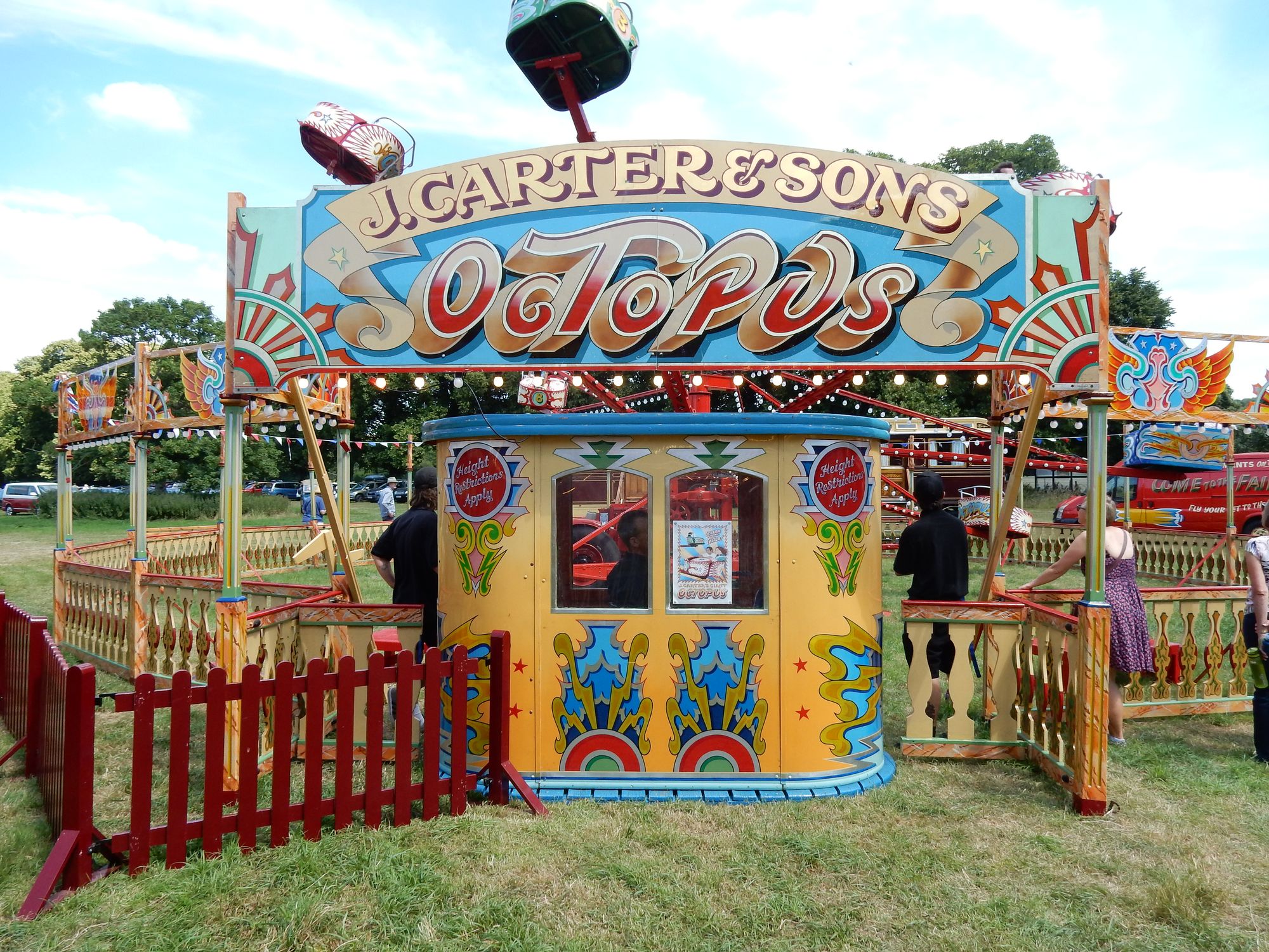 Fairground ride with elaborate painted decoration and lettering.