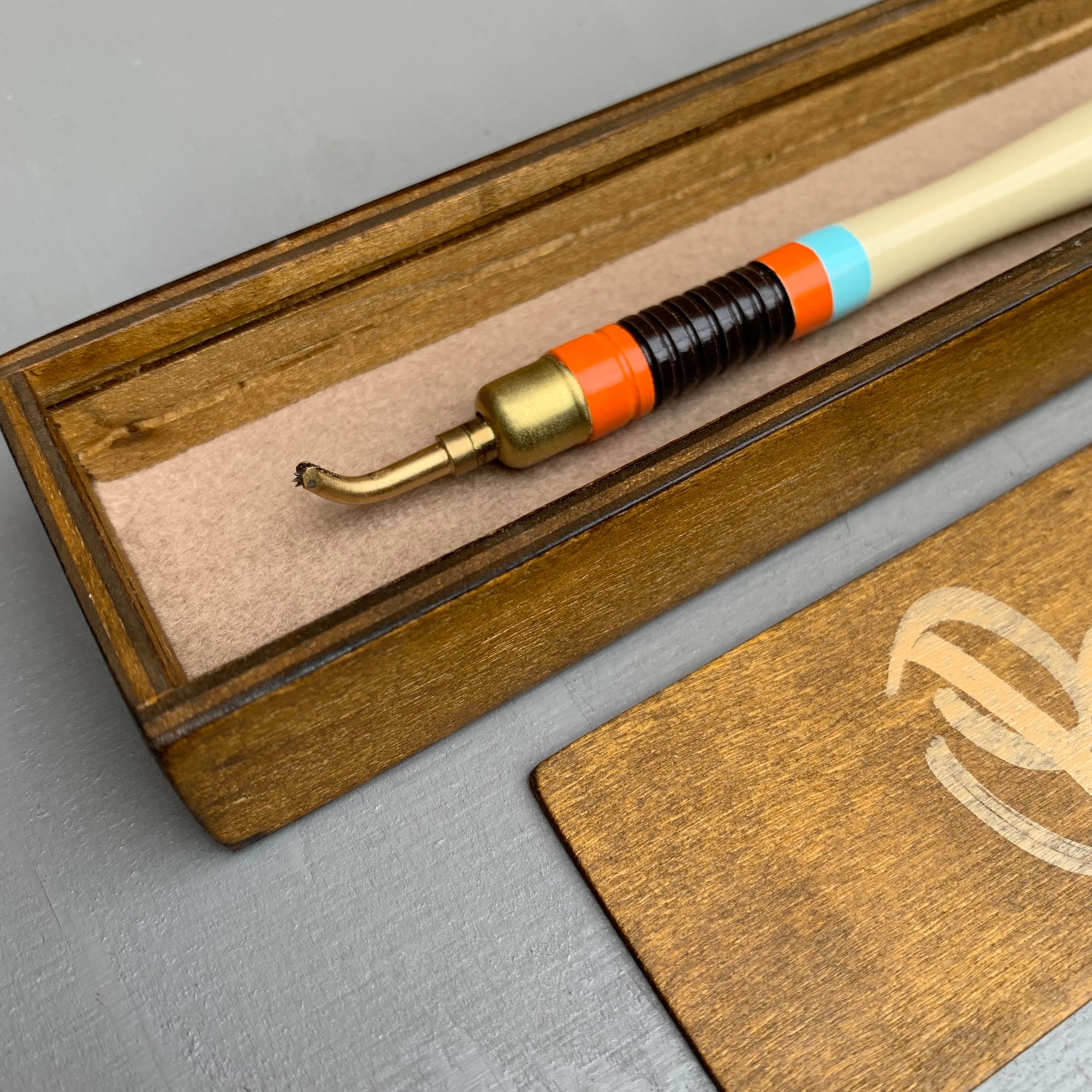 Pounce wheel in a wooden box.