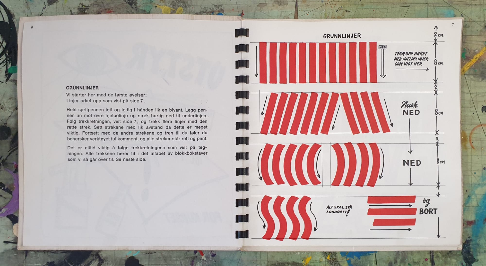 Spread from a ring-bound book with text on the left page, and a series of brush/pen strokes on the right.