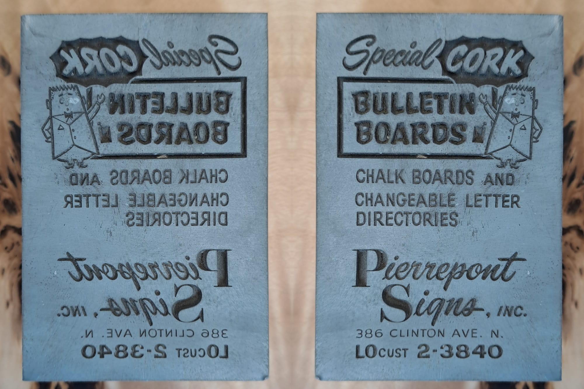 Face of a printing block shown as it is and then flipped horizontally to read correctly. It is an advertisement for the various sign services offer by Pierrepont Signs, and has a little mascot character gesturing in front of the 'Bulletin Boards' lettering that's set on a bulletin board shape..