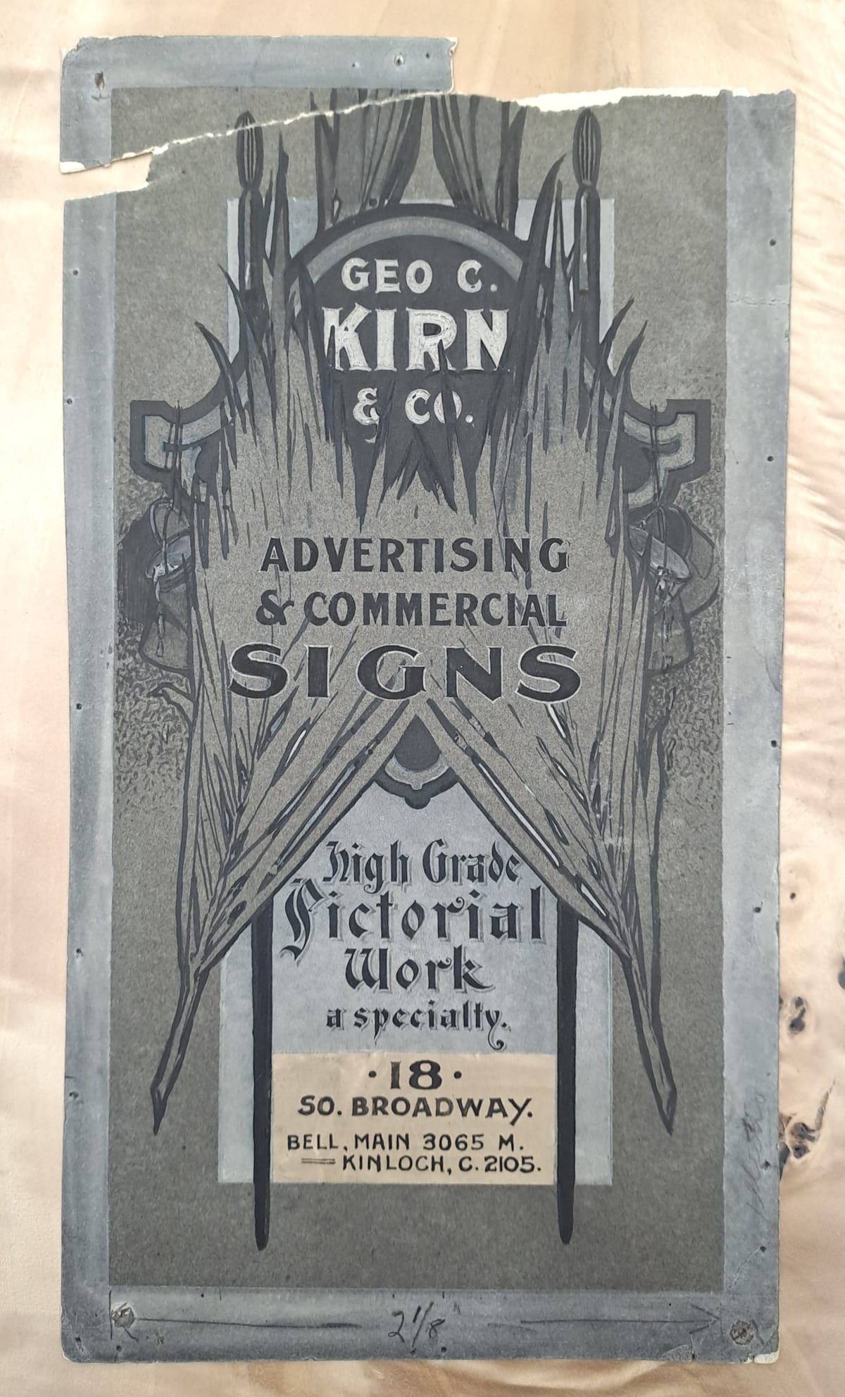 Extreme vertical artwork advertising "Geo C. Kirn & Co., Advertising & Commercial Signs, High Grade Pictorial Work a Specialty". The address is also given as 18 So. Broadway. Different parts of the lettering are set in front of, and behind, two overlapping feathers placed symmetrically on either side, and then behind those are two paint brushes.