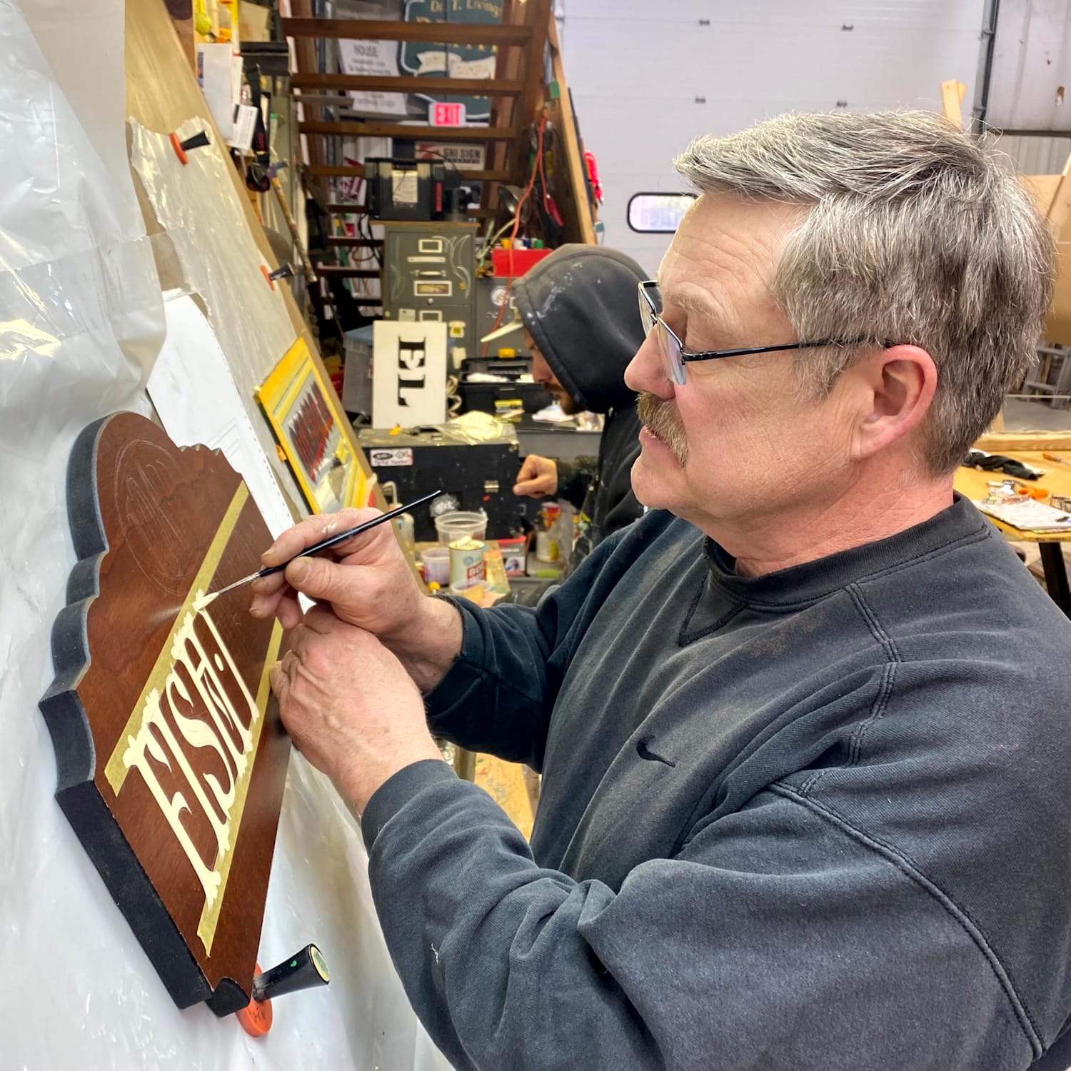 Main painting a wooden panel with cream coloured paint.