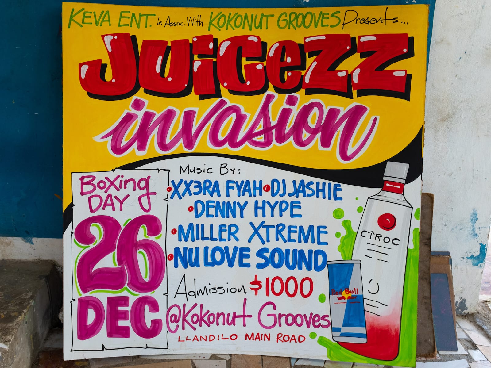 Brightly coloured painted square panel with the headline "Juicezz Invation" and then further details including "Boxing Day, 26 December" and "Music by XX3RA FYAR, DJ Jashie, Denny Hype" and others.