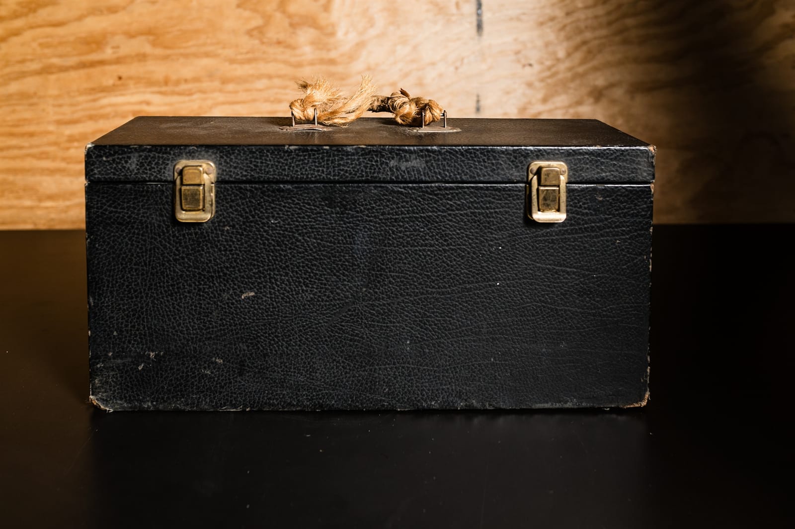 A simple black oblong case with metal fasteners.