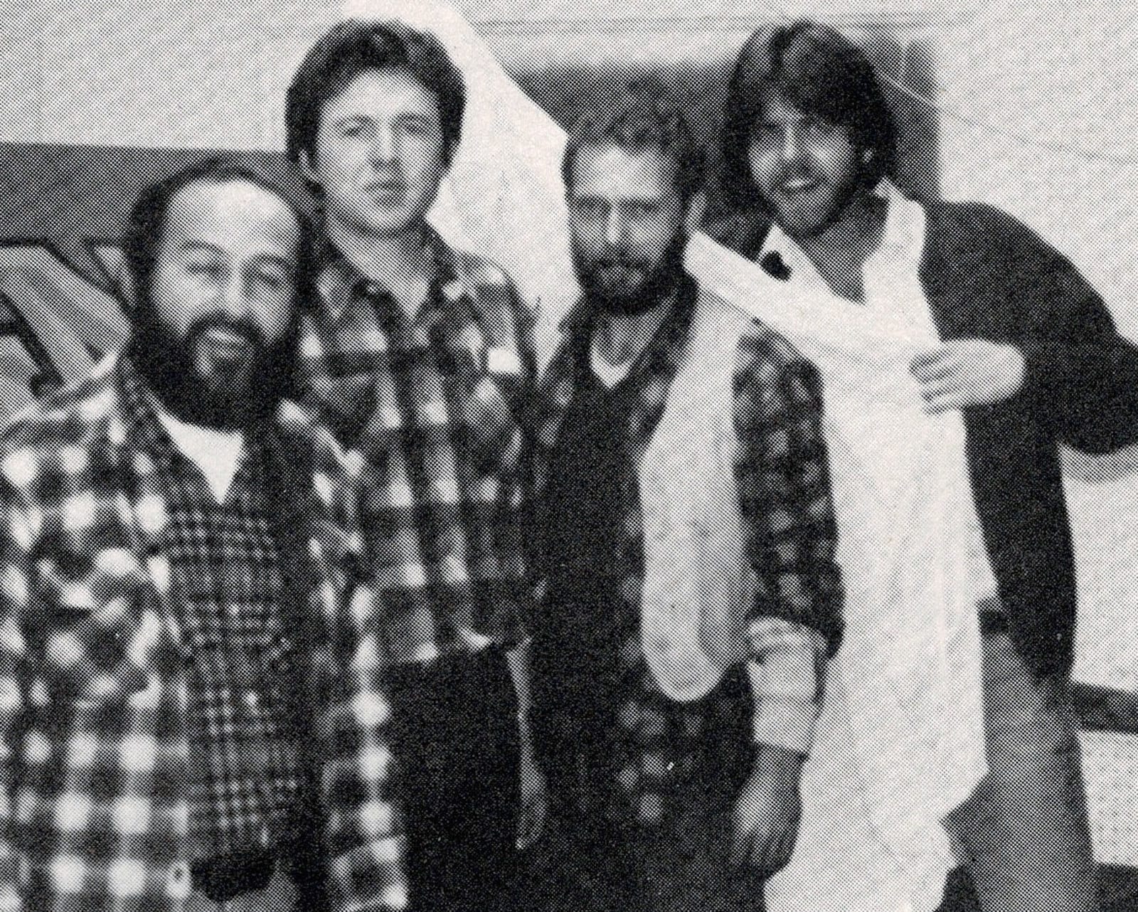 Black and white portrait of four men.