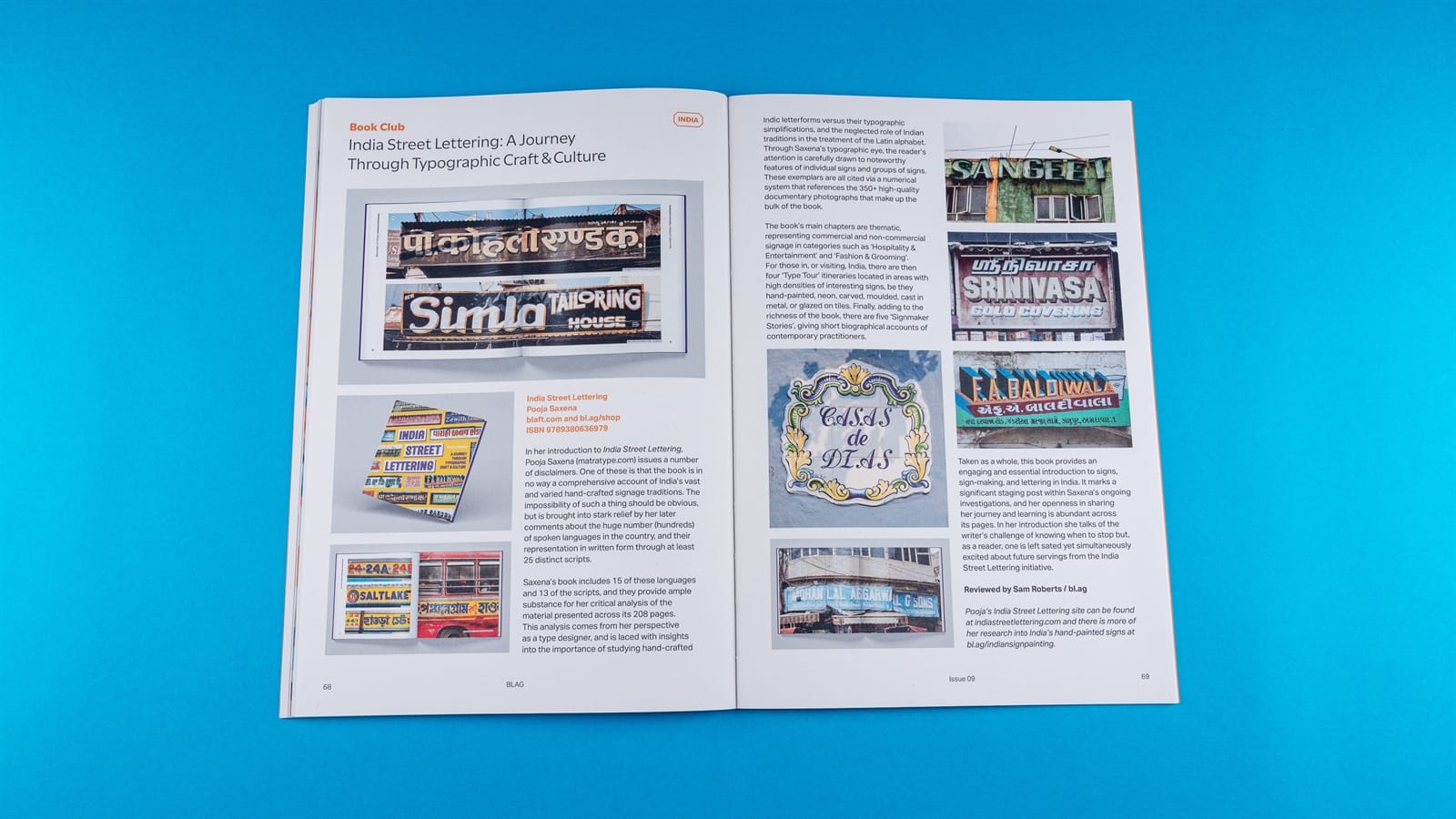 Photo of a spread from a magazine set on a light blue background. The section header is "Book Club" with the featured article titled "India Street Lettering: A Journey Through Typographic Craft & Culture". The image-led piece shows a variety of signs in various scripts alongside a short review of the book.