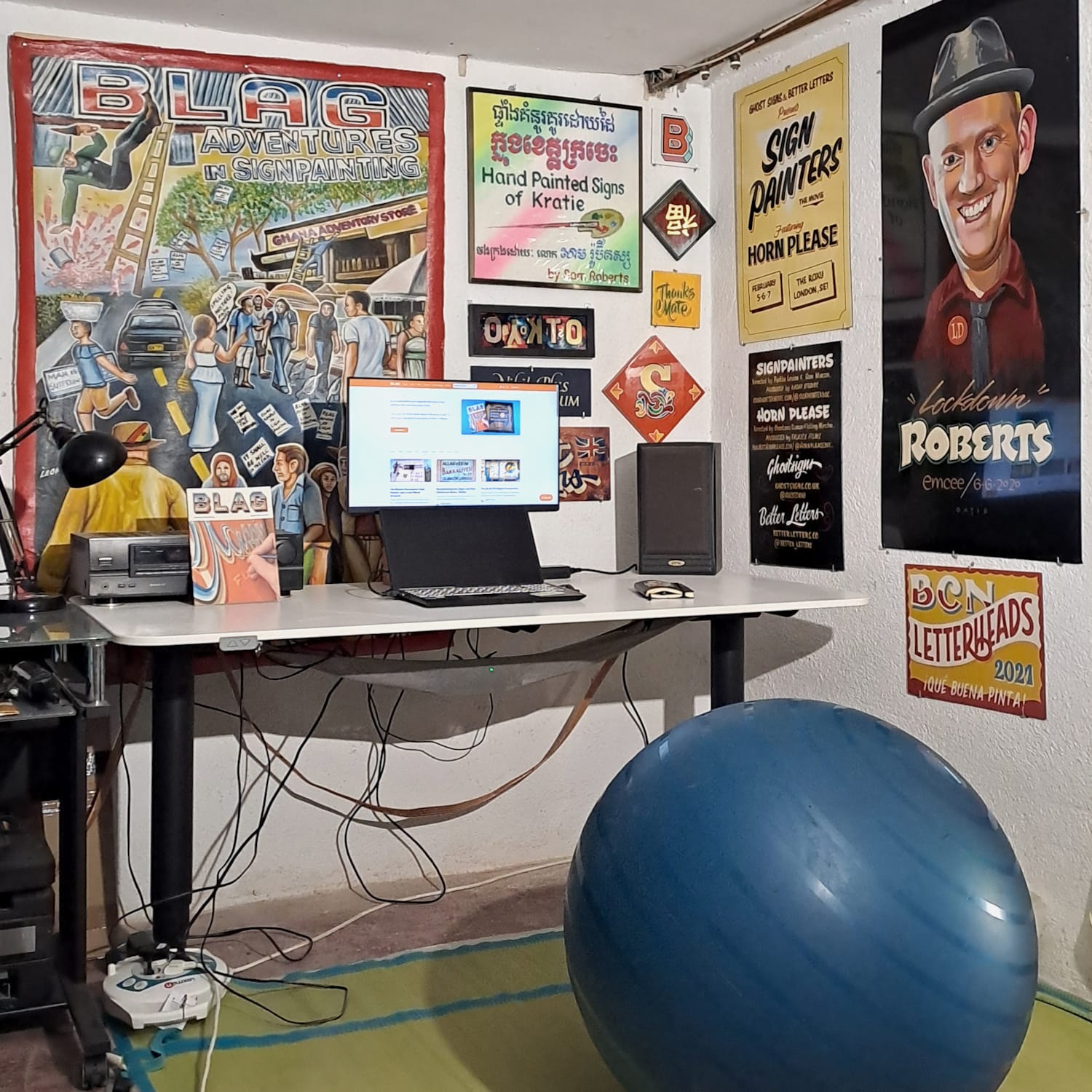 Detail of the desk and the signs on the portions of wall in front and to the right of the desk.