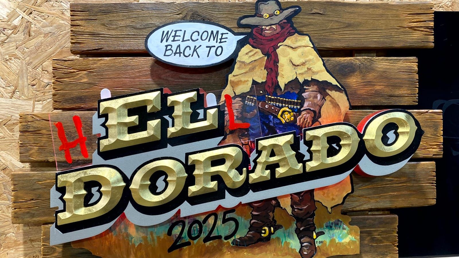 Painted and gilded panel with a cowboy pictured saying "Welcome Back To" above the main lettering that reads "El Dorado".