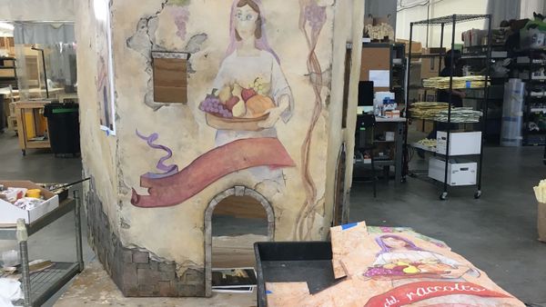 Scenic painting work in a studio environment.