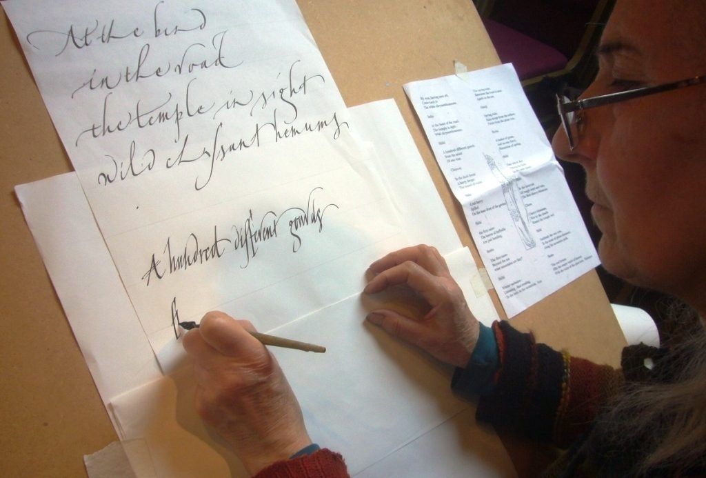 Gaynor Goffe demonstrating her calligraphy, working left handed
